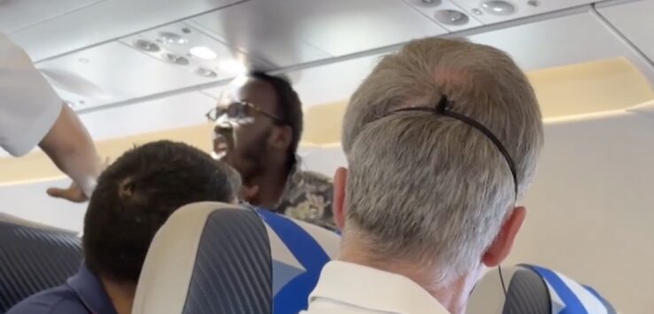 a group of men sitting on an airplane