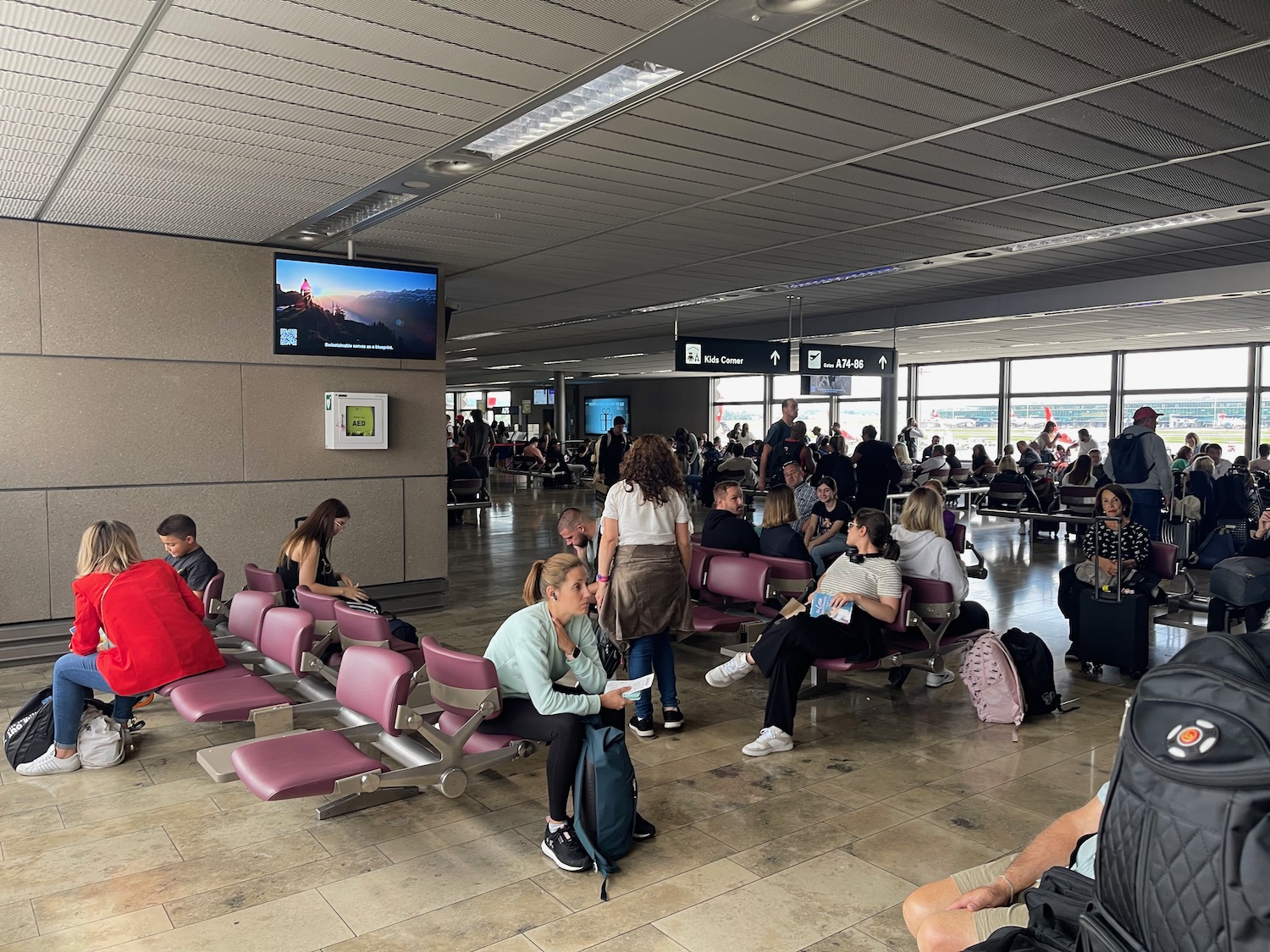 a group of people sitting in chairs in an airport