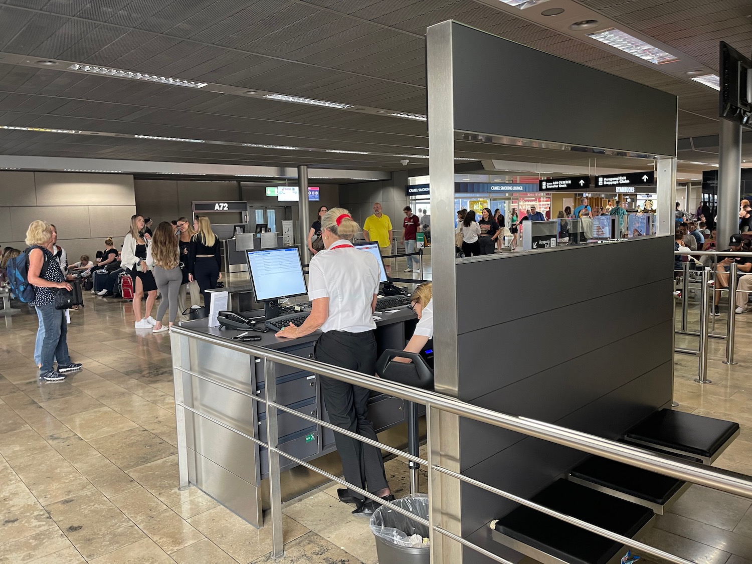 people at a counter in an airport