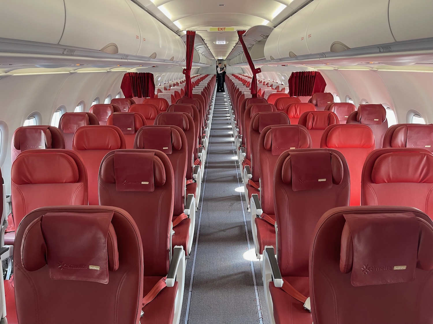 a row of red seats on an airplane