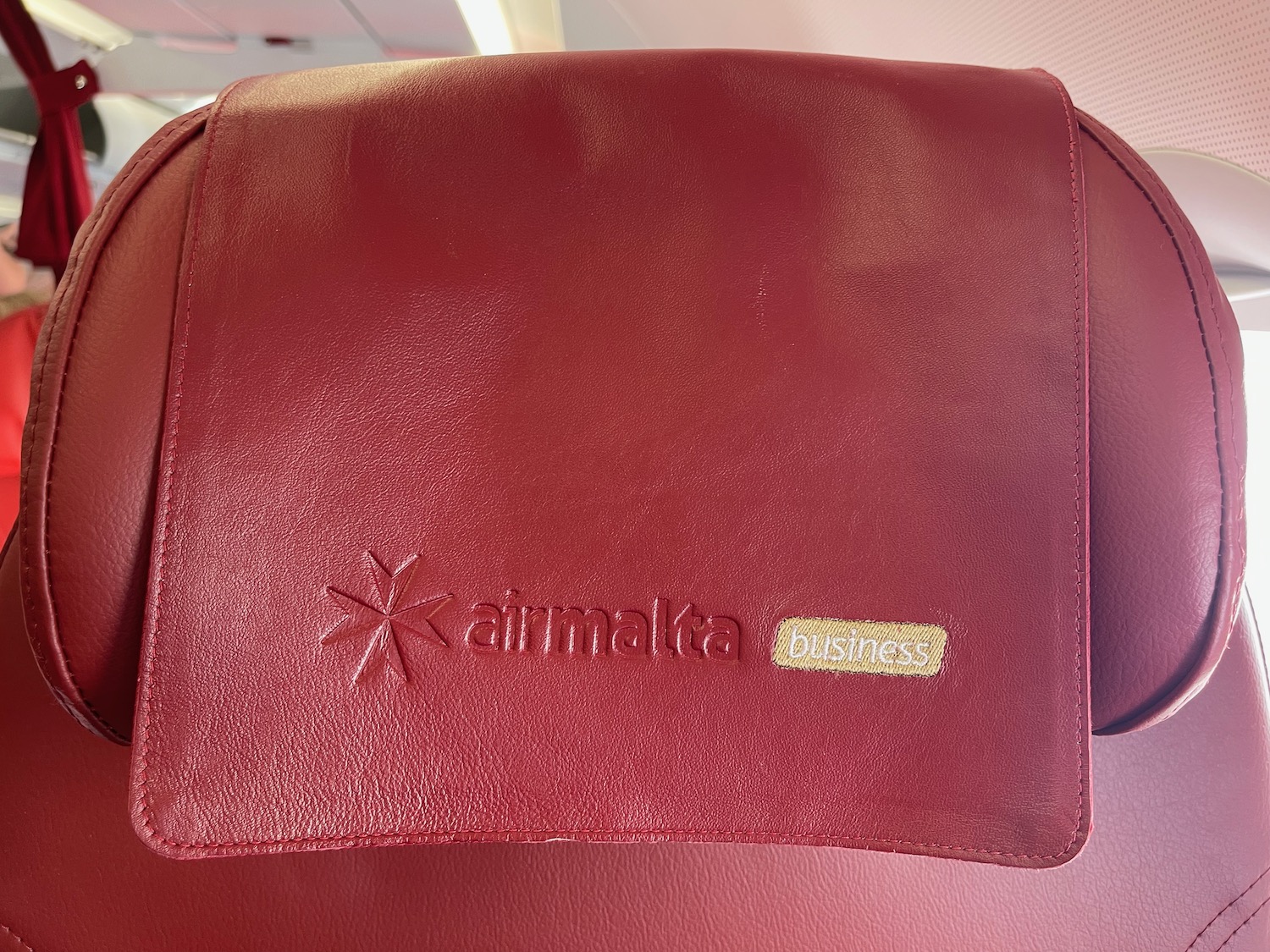 a red leather bag with a logo on it