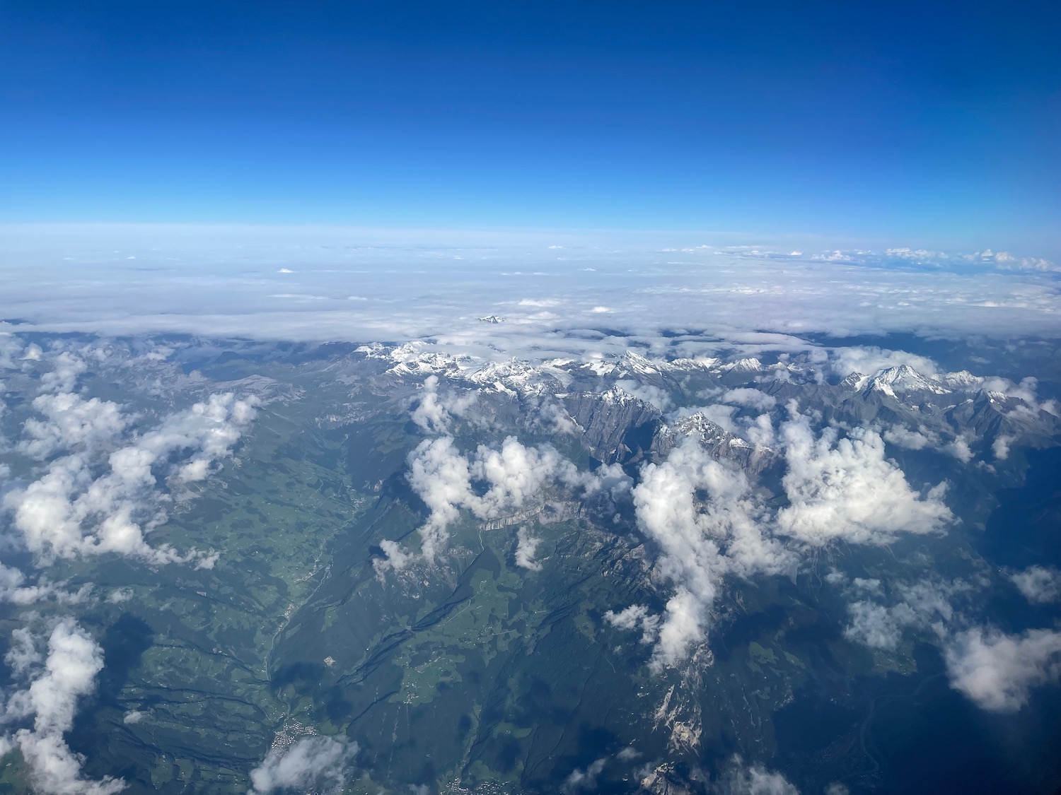 aerial view of a mountain range and clouds