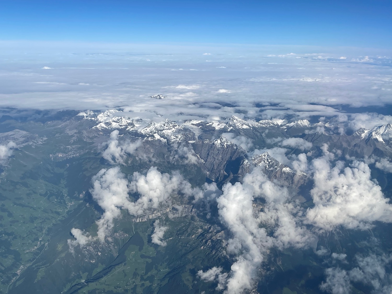 aerial view of a mountain range with clouds