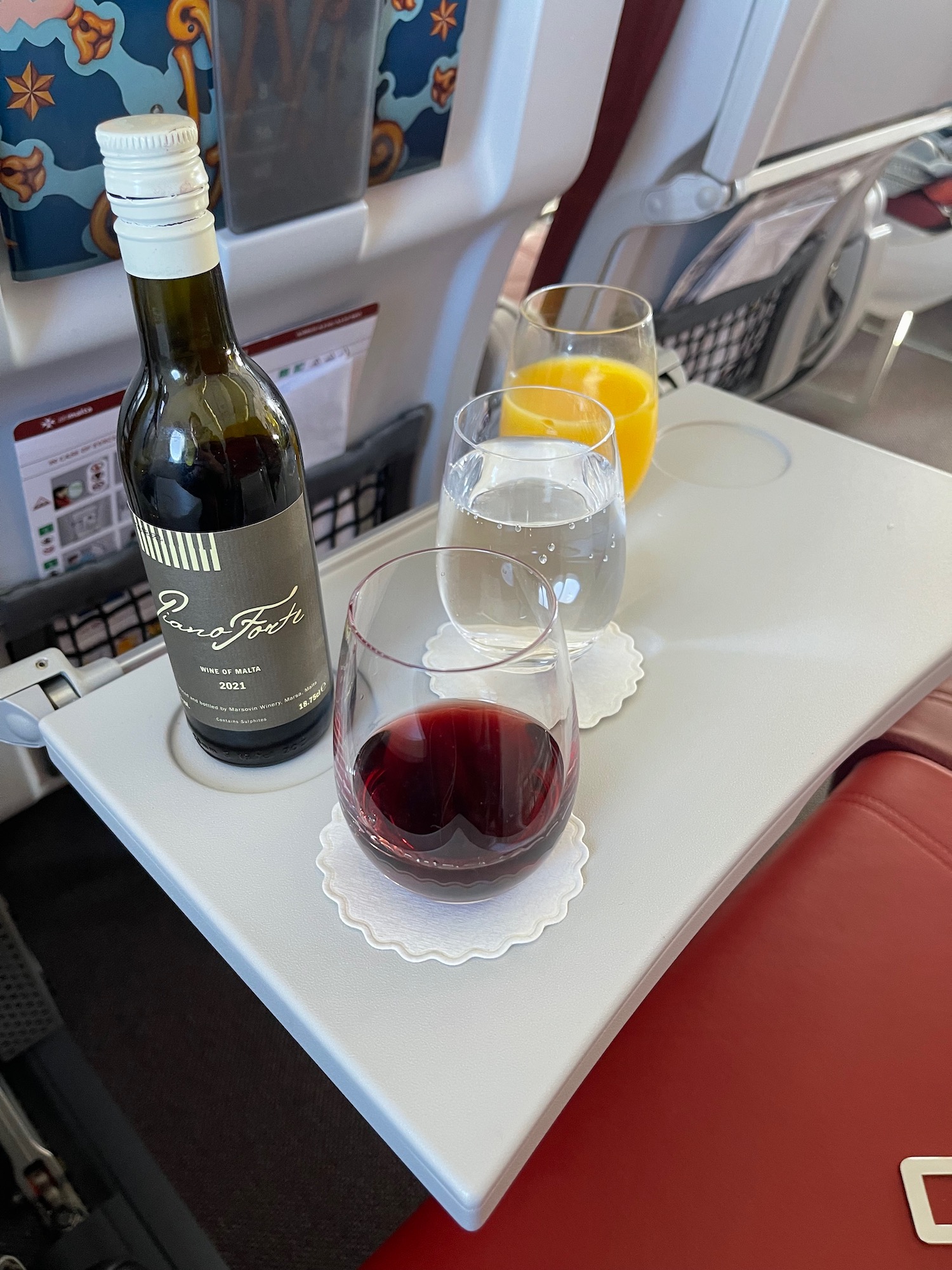 a wine bottle and glasses on a tray