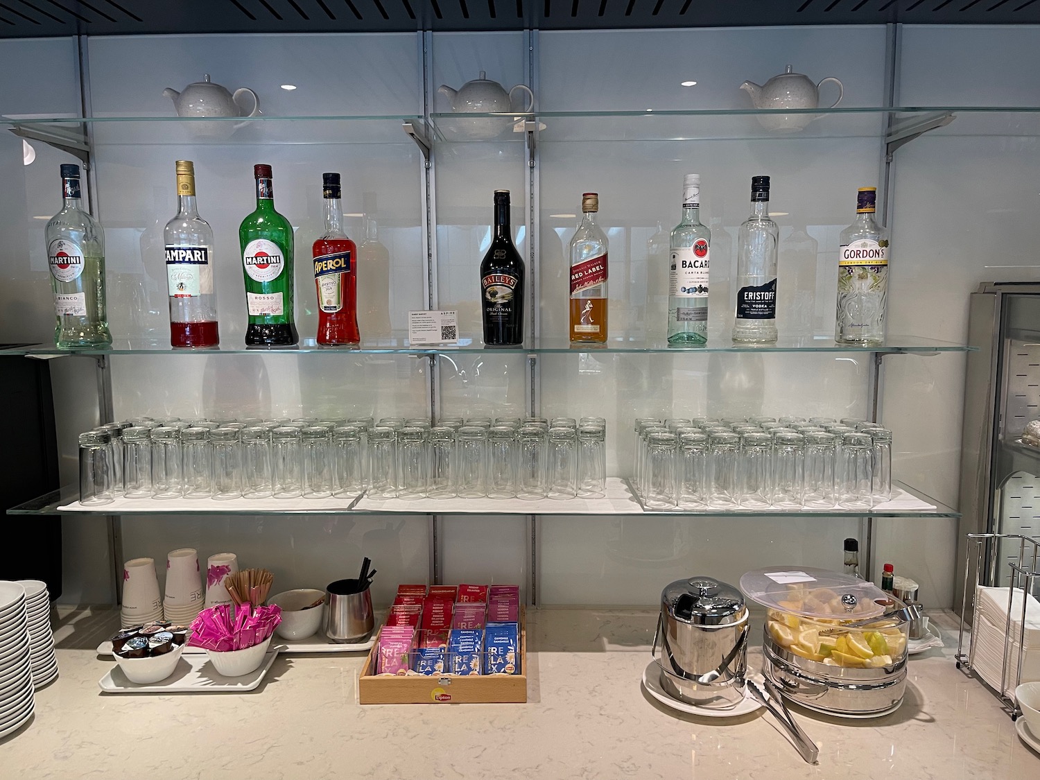 a shelf with bottles and glasses on it