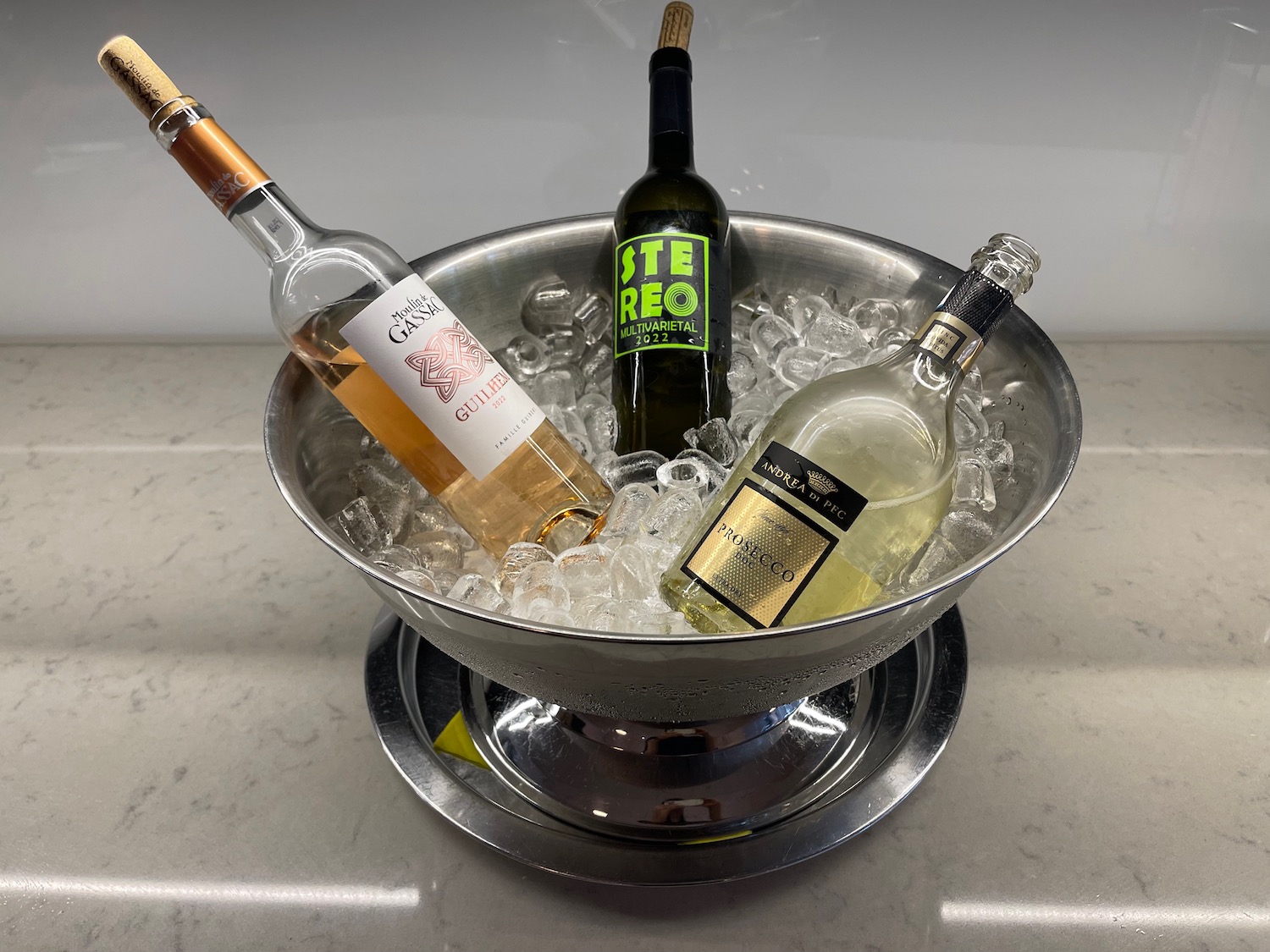 a silver bowl with bottles of wine in it