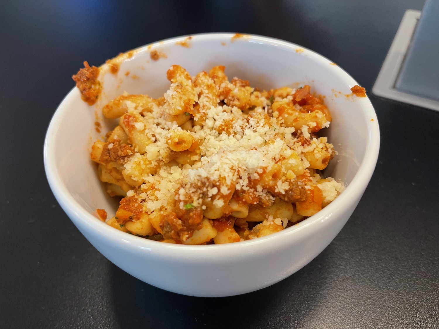 a bowl of pasta with cheese and sauce