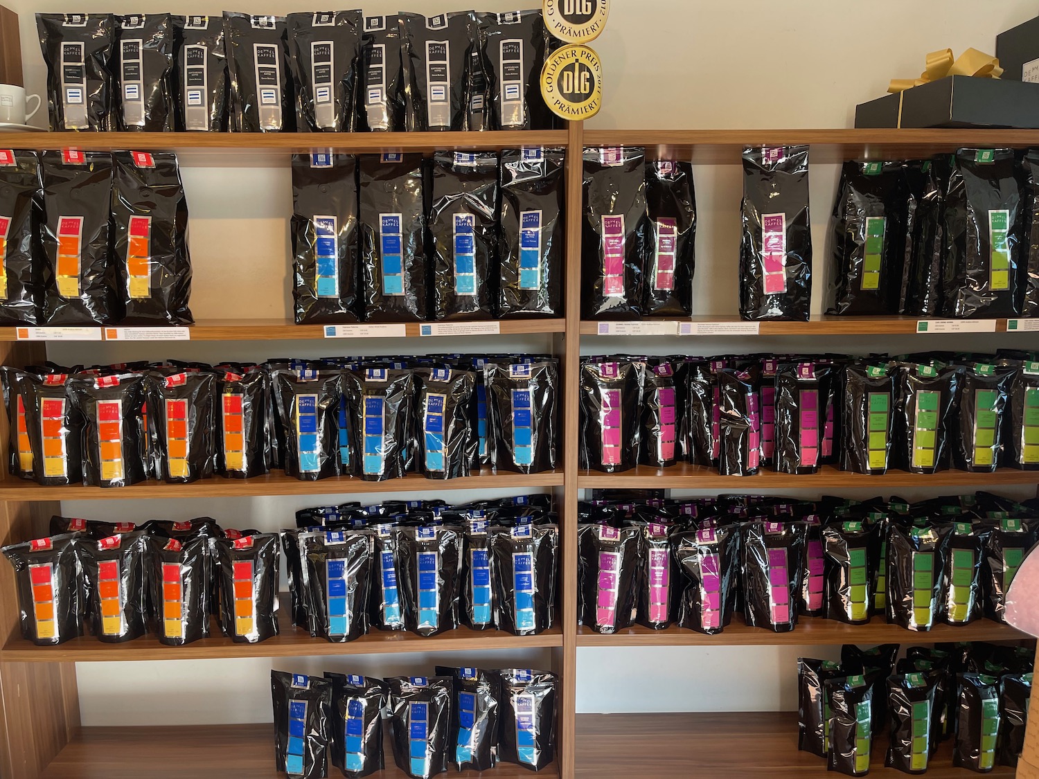shelves of black bags with different colors on them