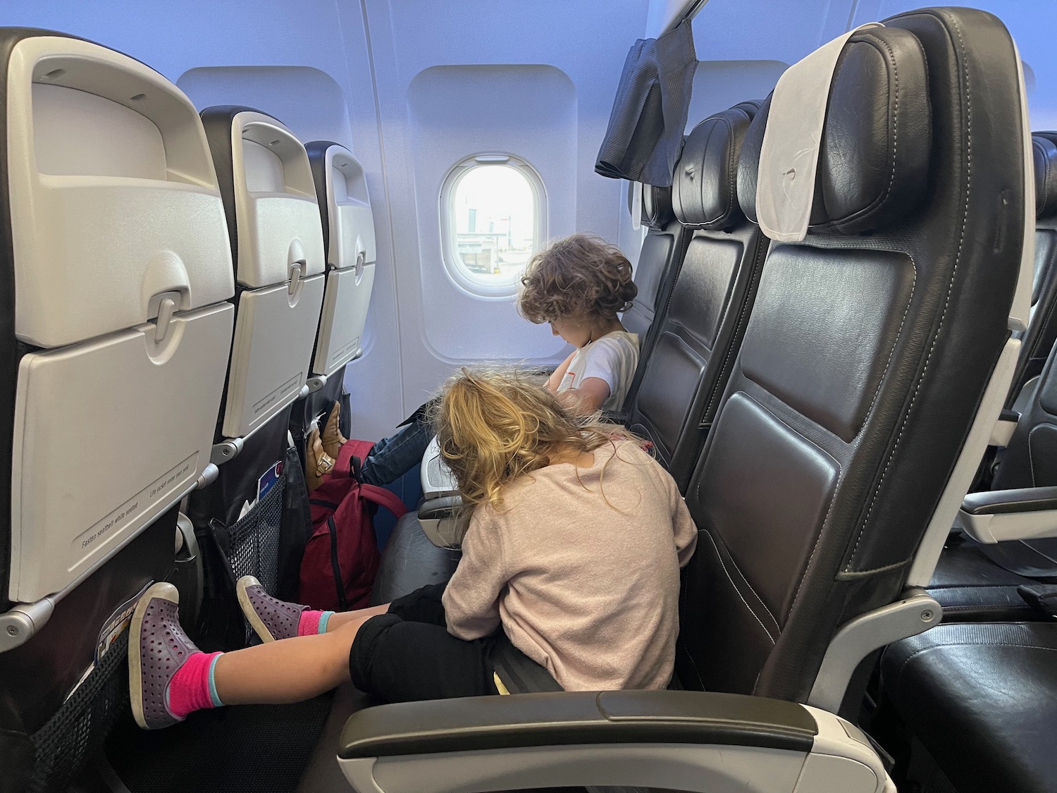 two children sitting in an airplane