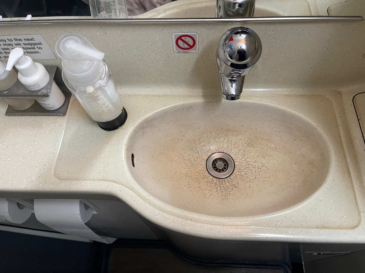 a sink with soap dispenser and soap dispenser