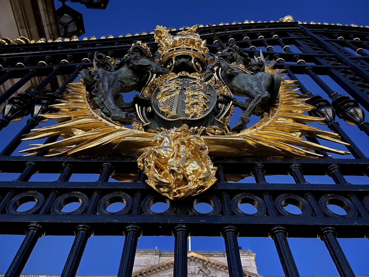 a black and gold gate with a gold crest
