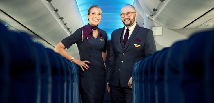 a man and woman standing in an airplane