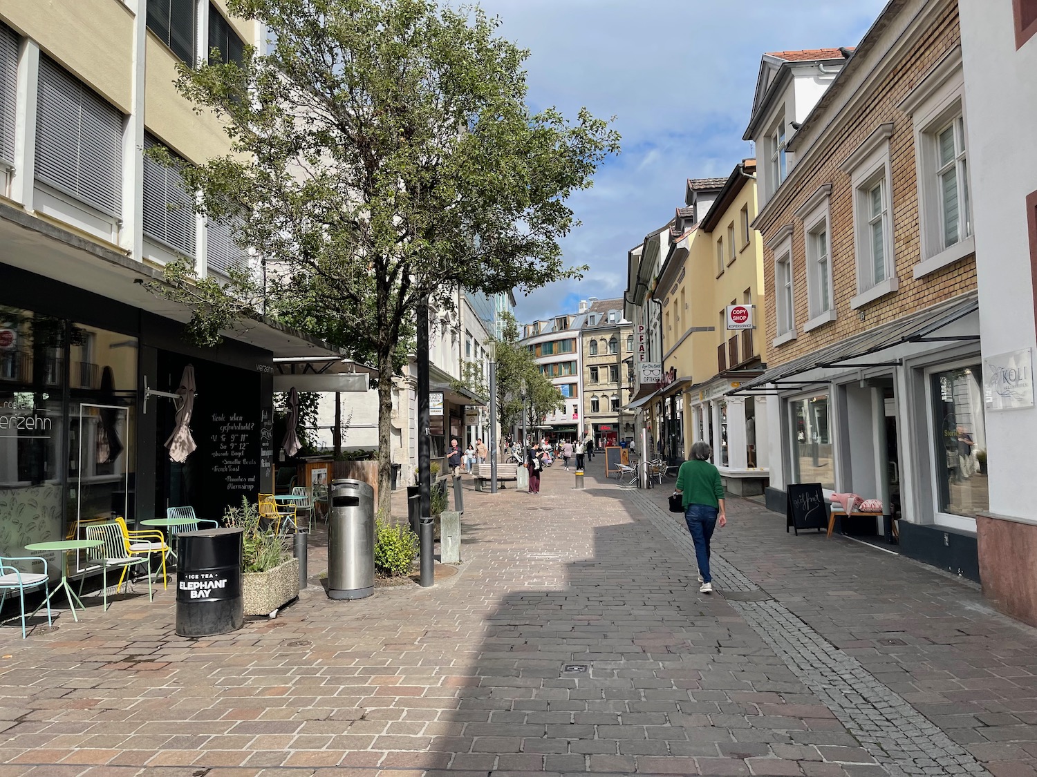 a person walking down a brick walkway