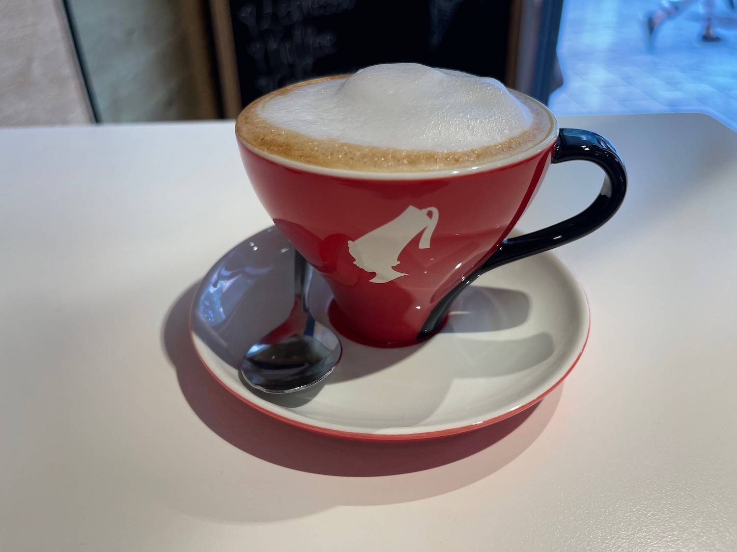 a red cup with a white foamy foam in it