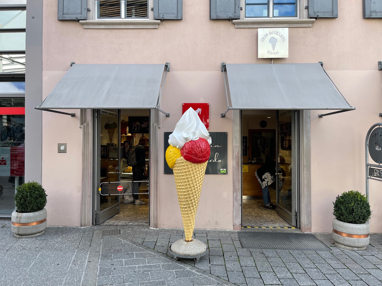 a large ice cream cone statue in front of a building
