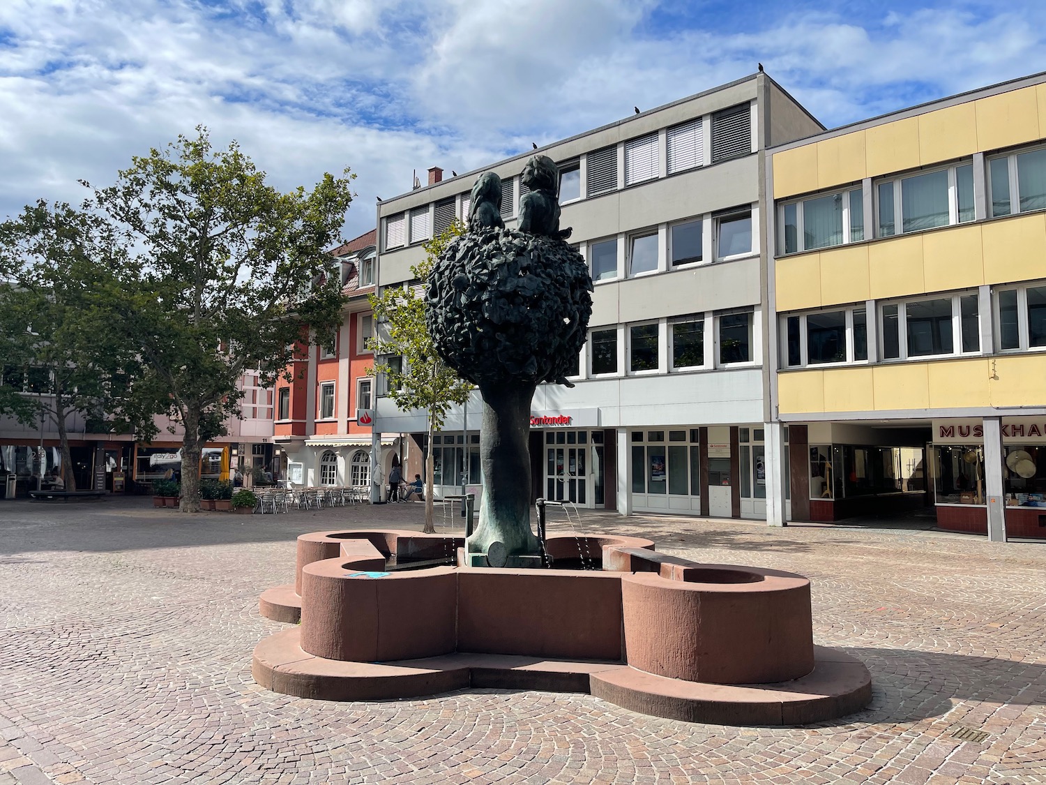 a statue of a tree with a bird on top of it