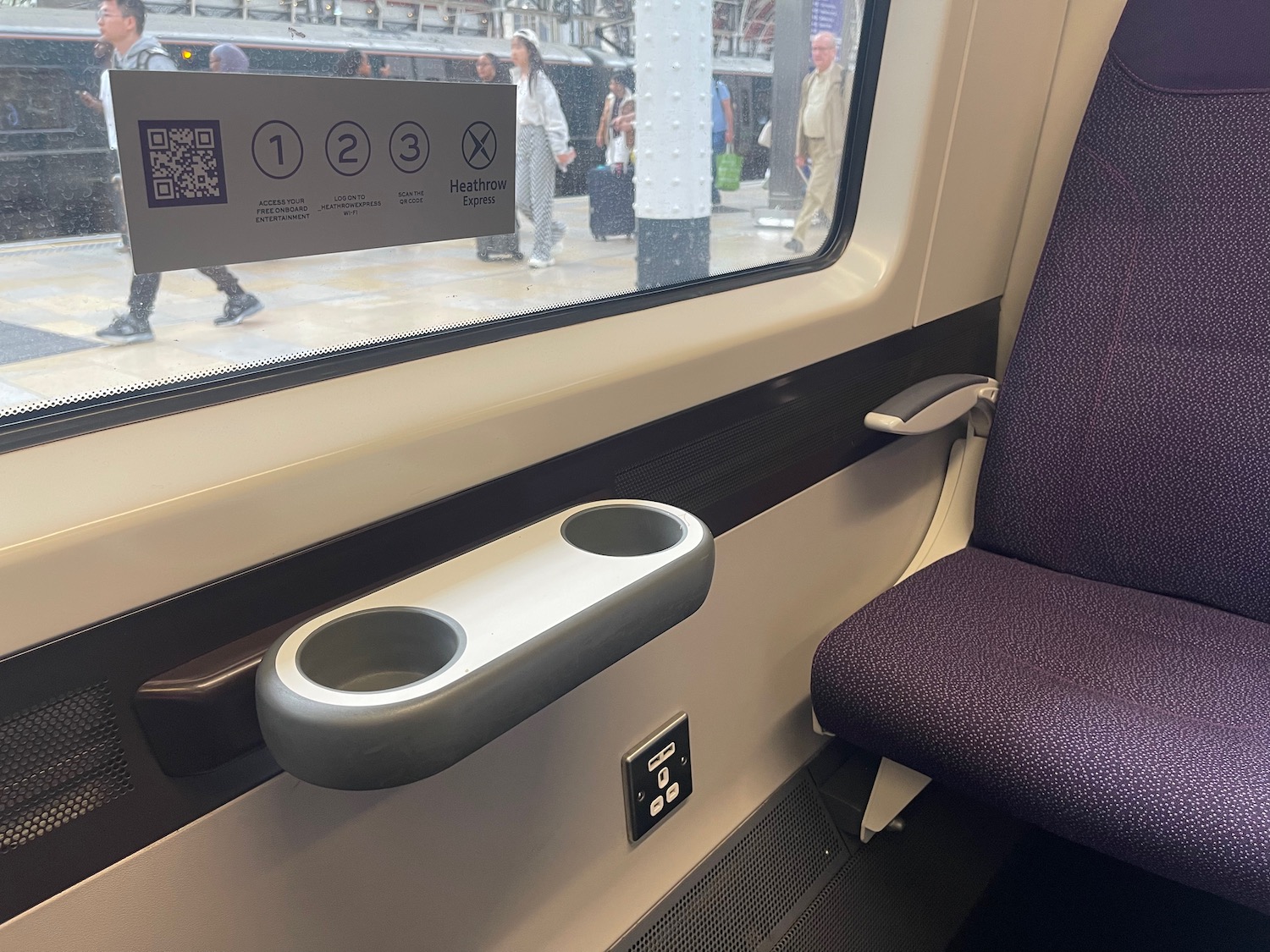 a seat and arm rest on a train
