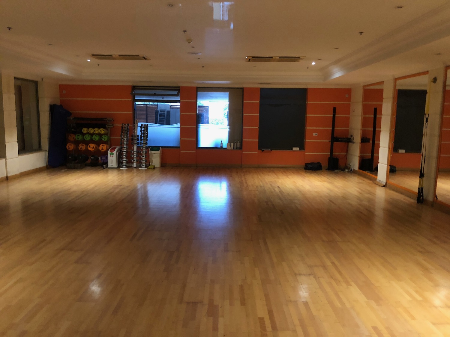 a large room with orange walls and a wood floor