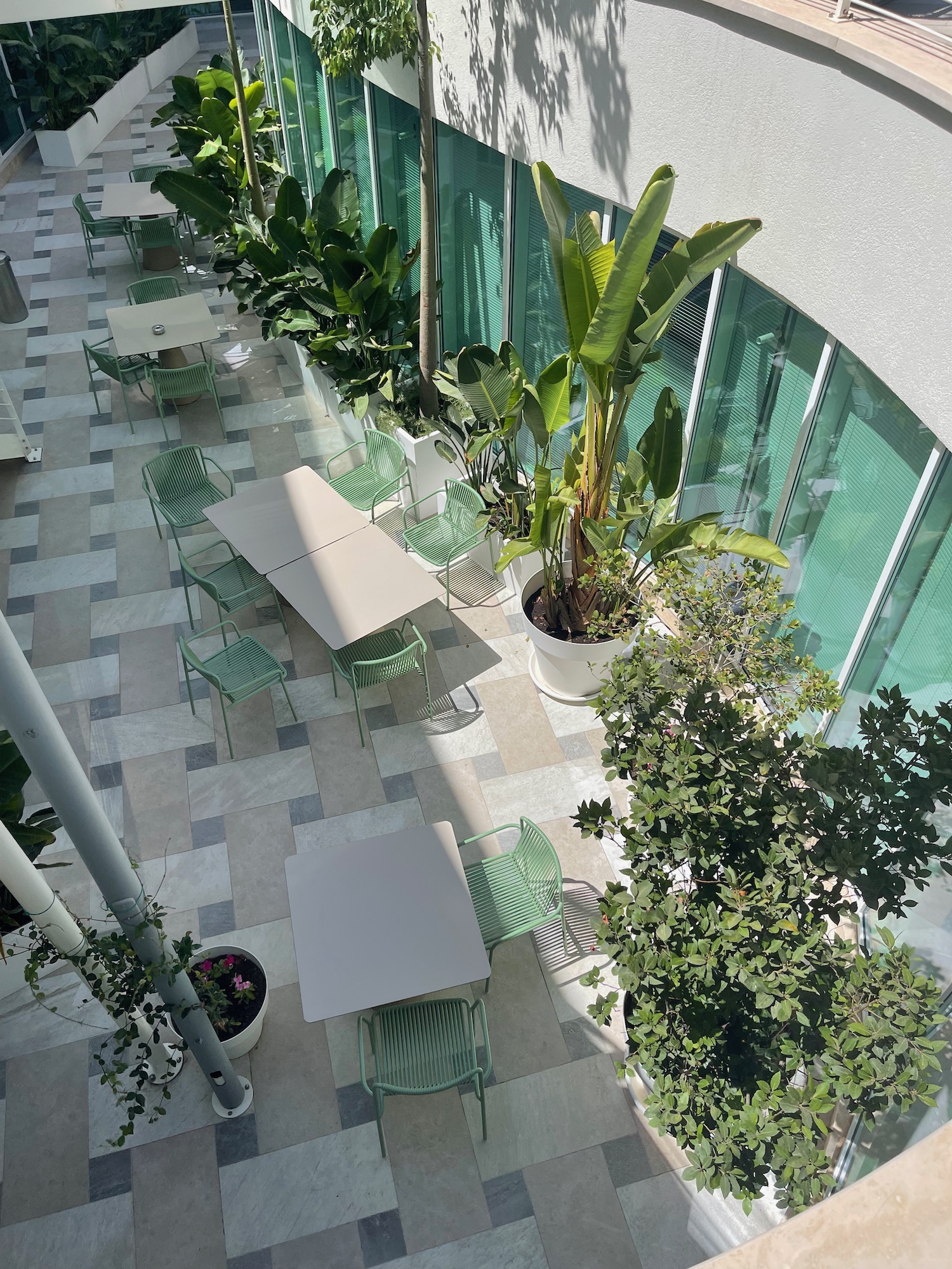a patio with tables and chairs and trees