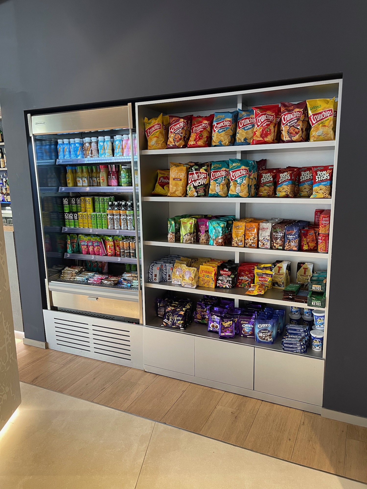 a display case with snacks and drinks on shelves