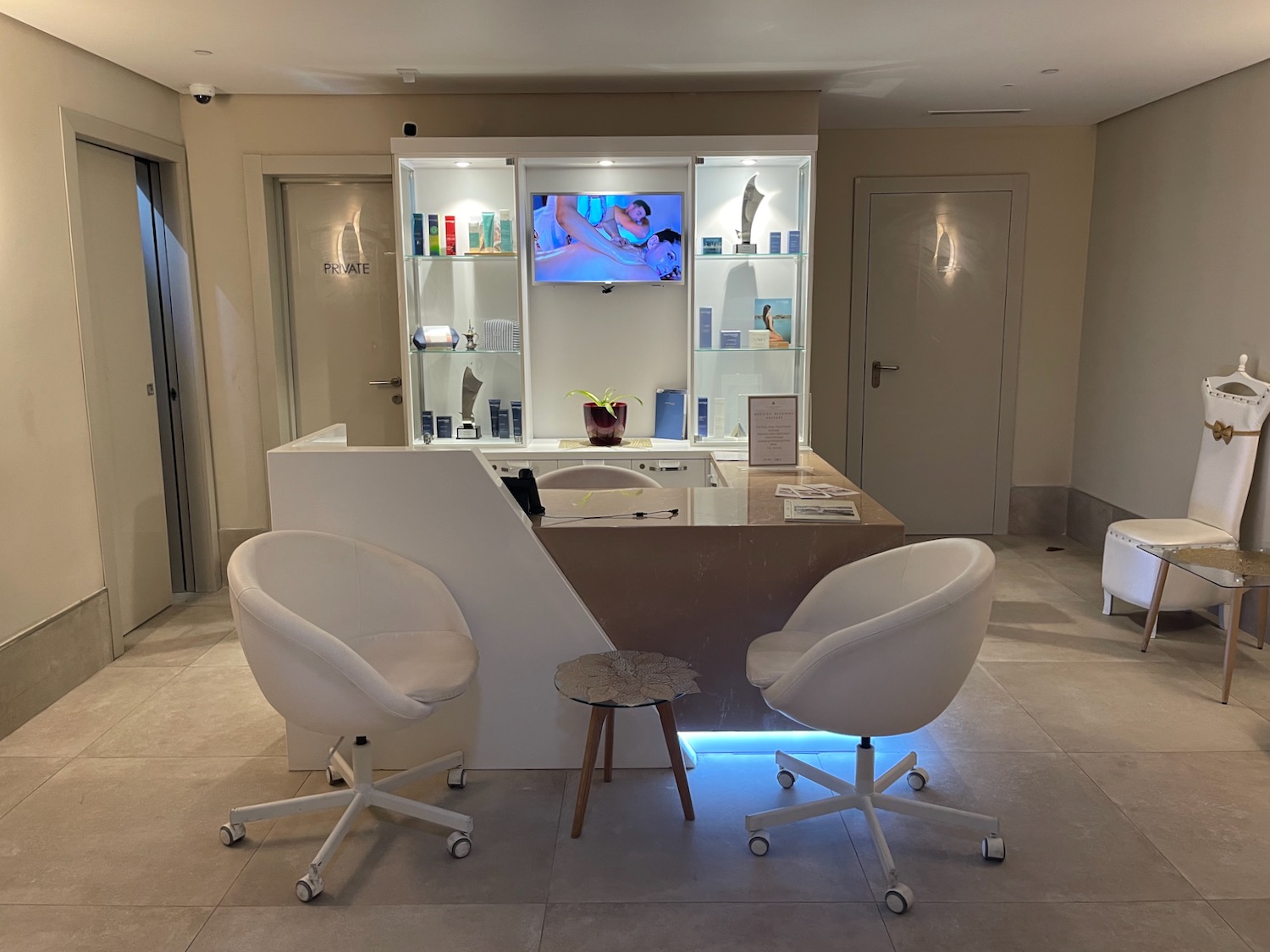 a room with a reception desk and chairs