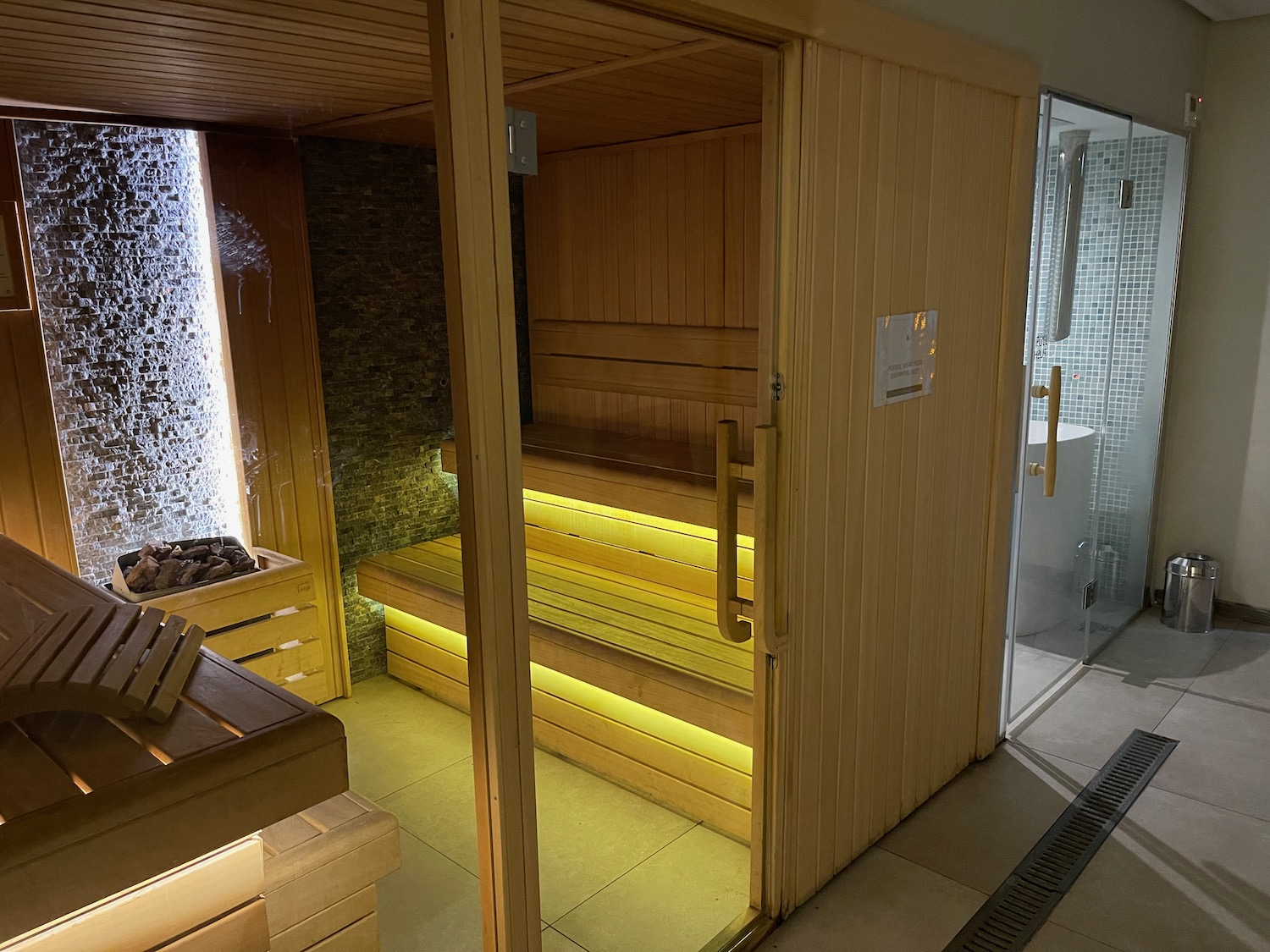 a sauna with a glass door