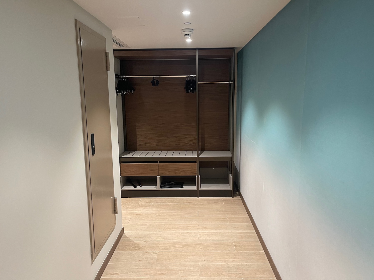 a hallway with a closet and a door