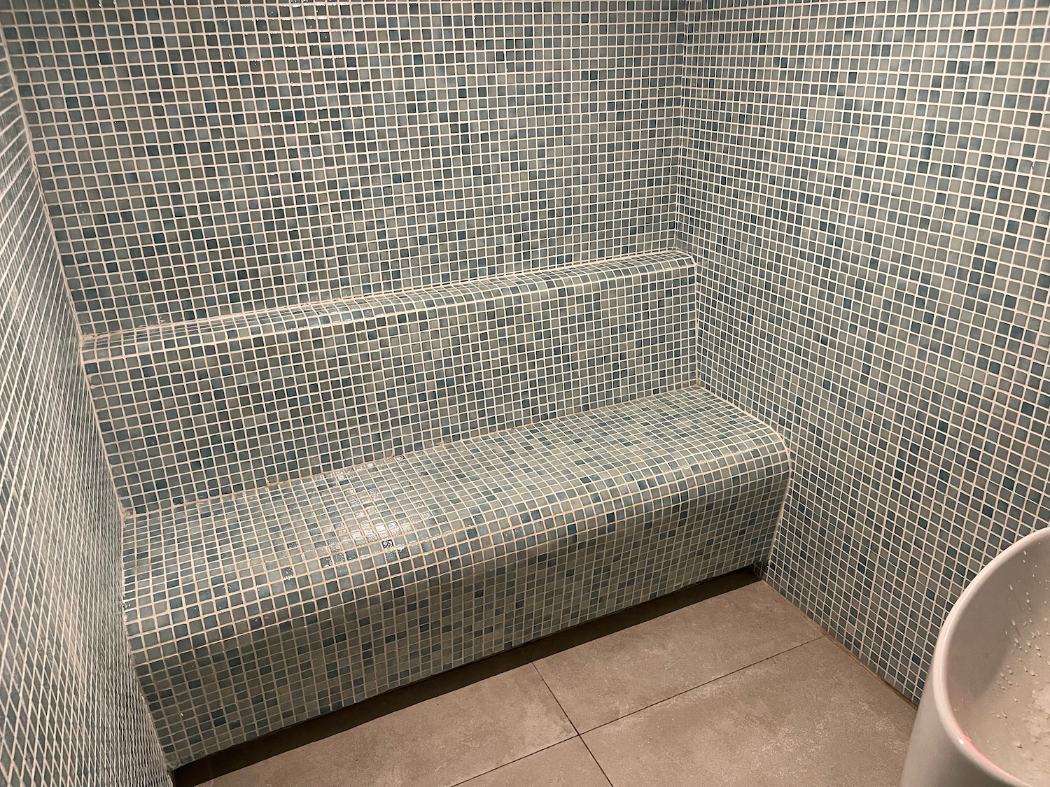a tiled bench in a shower