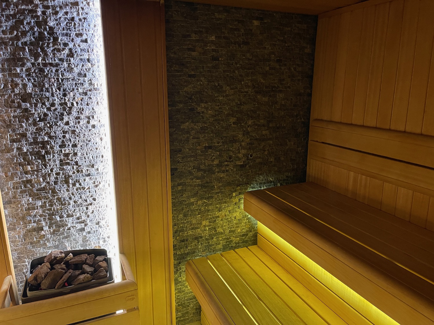 a sauna with lights and a stone wall