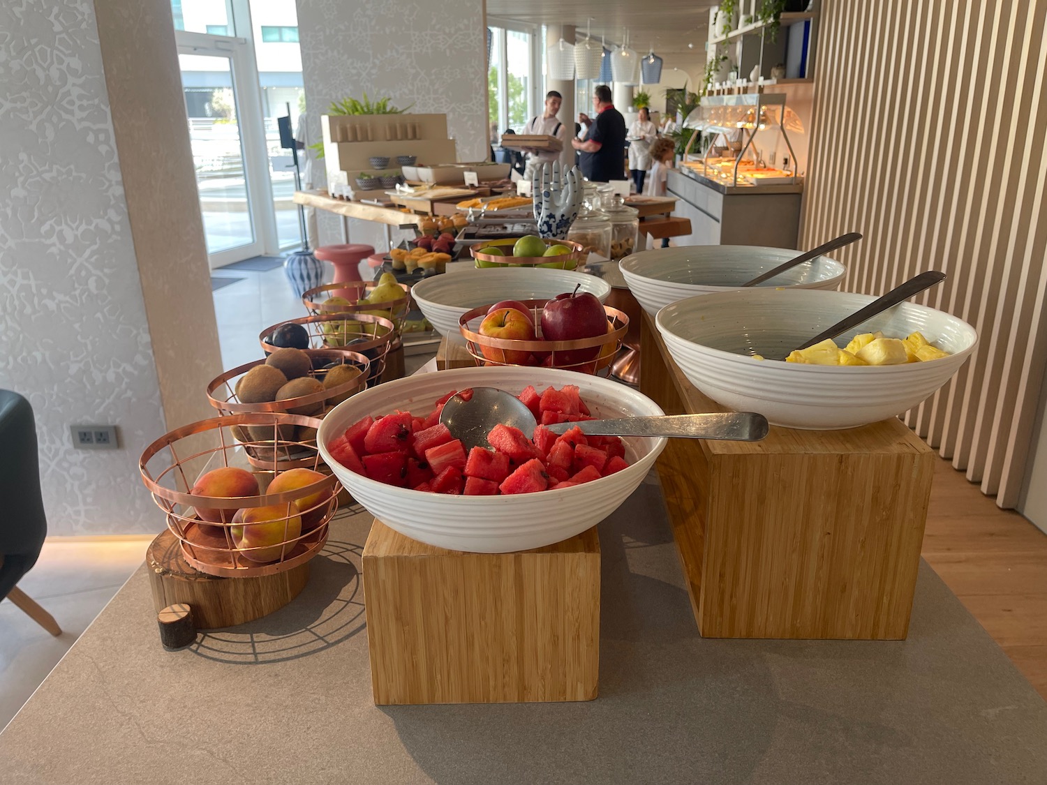 a buffet table with bowls of fruit