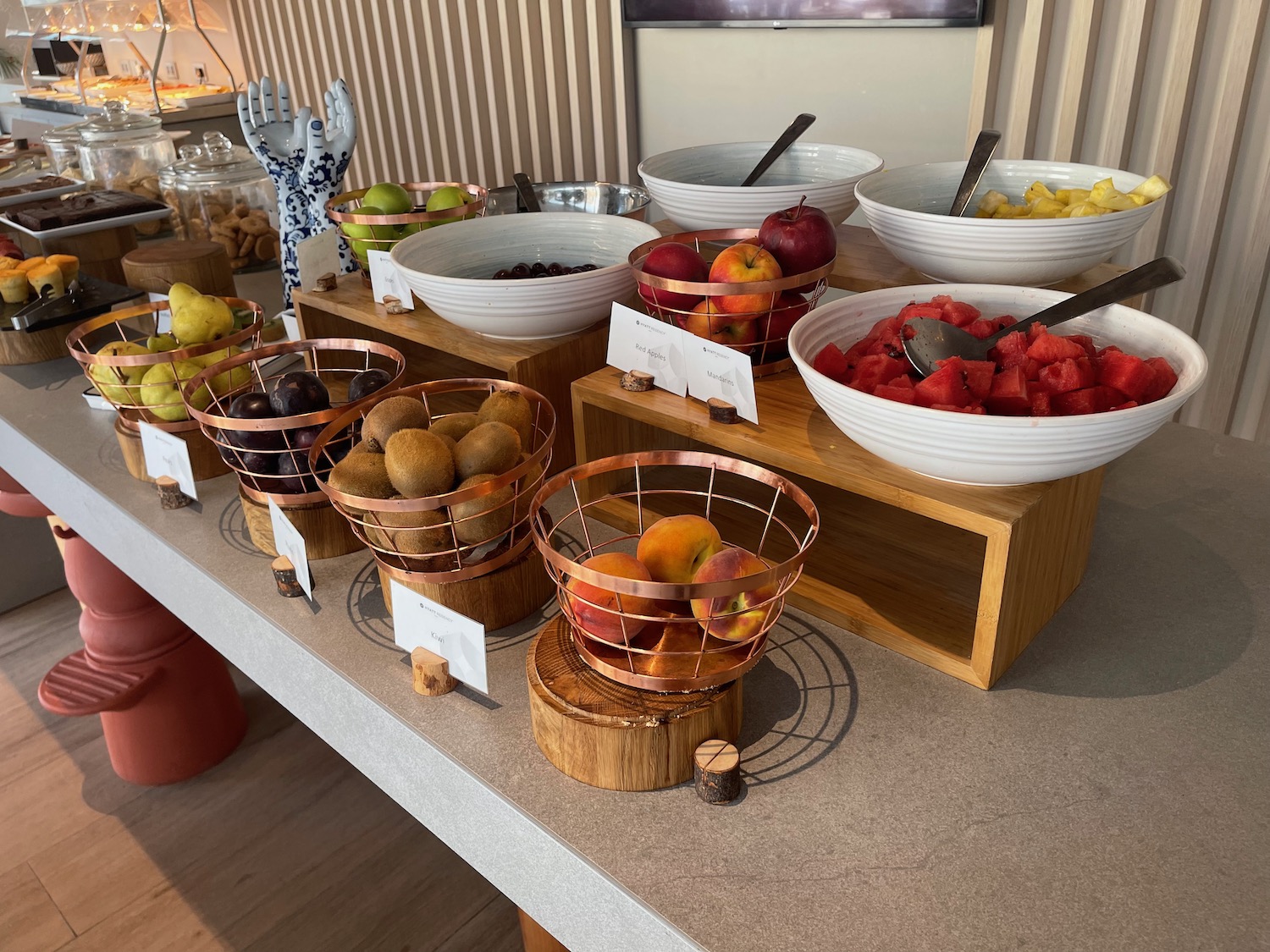 a table with bowls of fruit