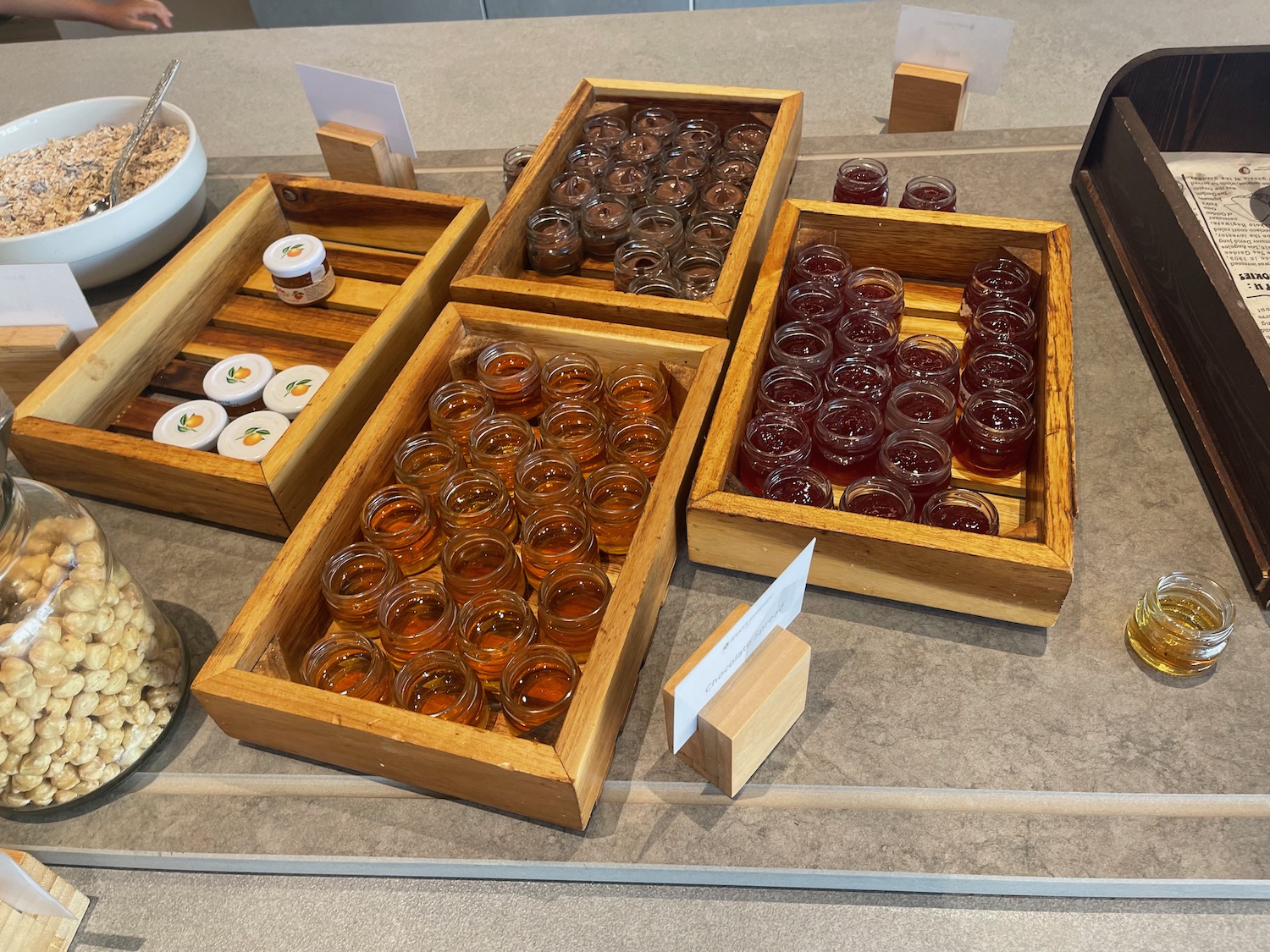 a group of small jars of liquid in a wooden box