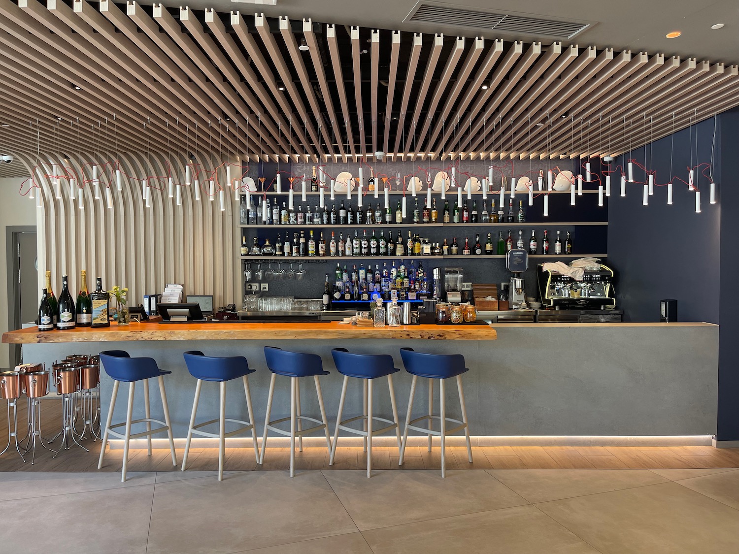 a bar with blue chairs and a bar with blue stools