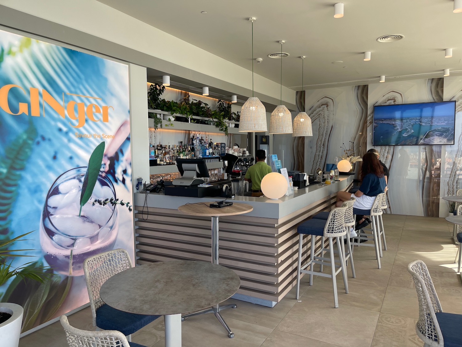 a bar with people sitting at the counter