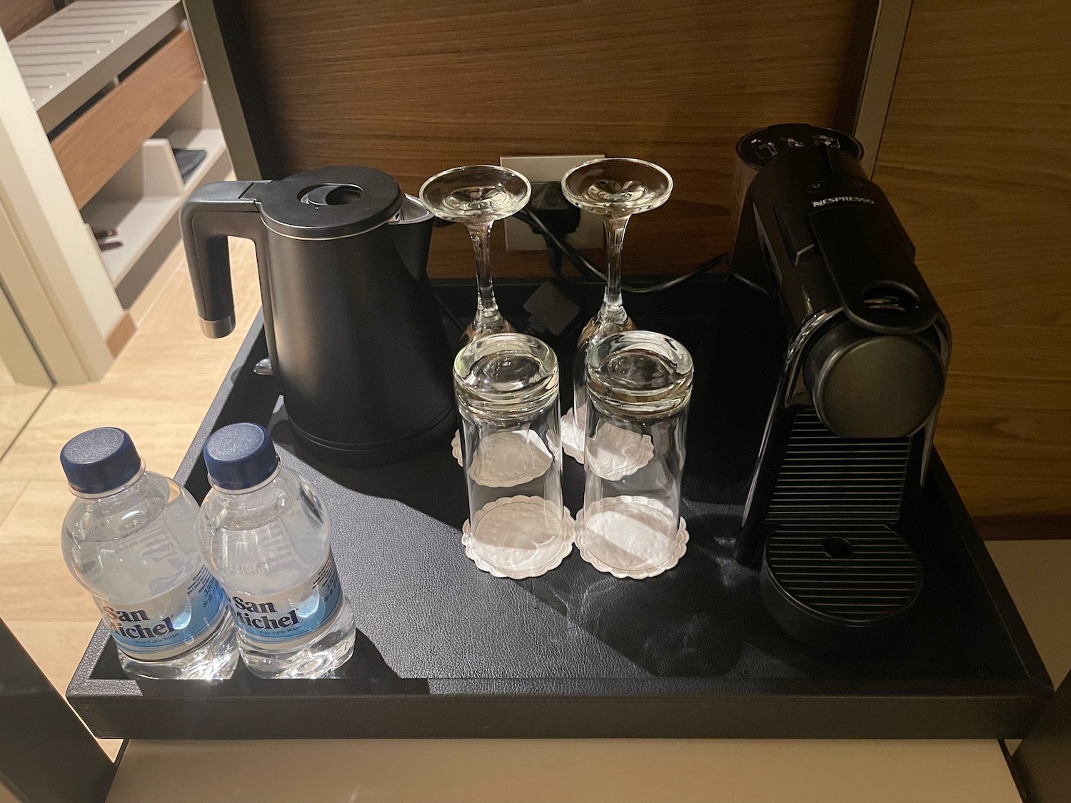 a coffee machine and glasses on a tray