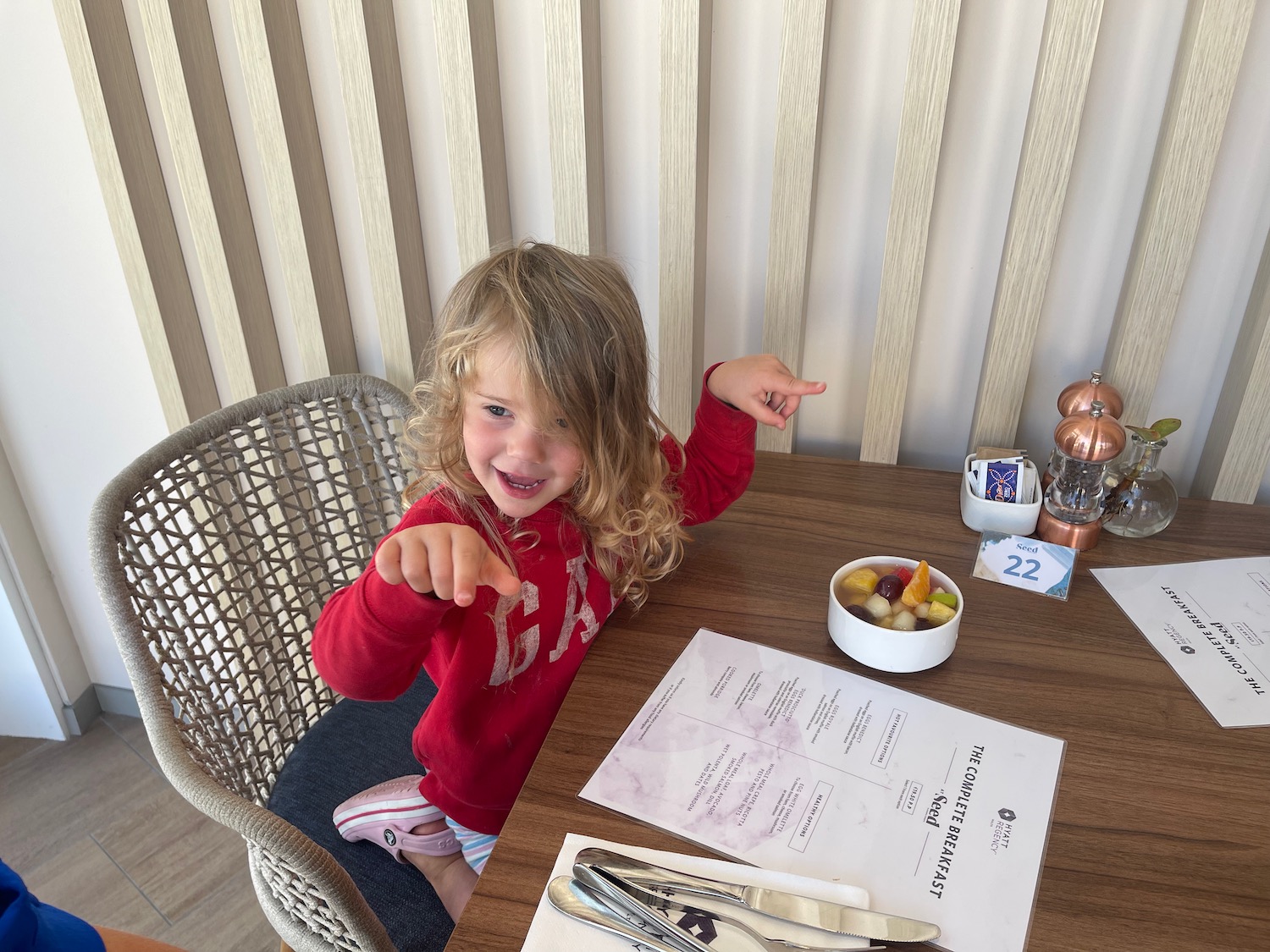 a girl pointing at a table