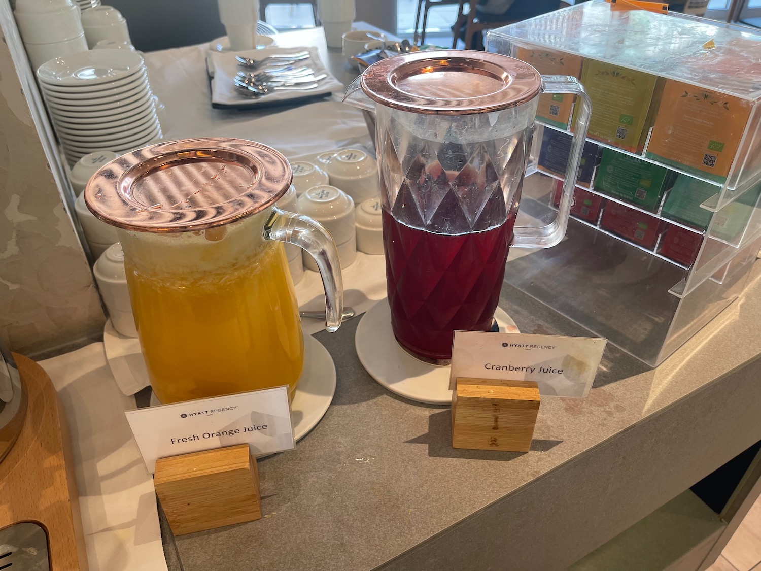 a table with a pitcher of juice and a pitcher of orange juice