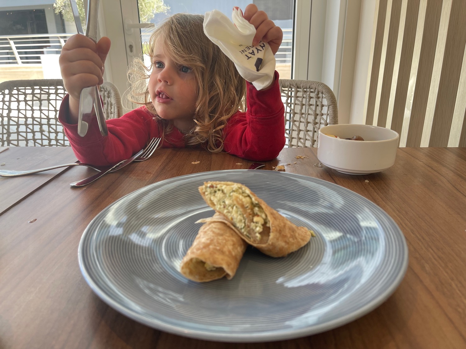 a child eating food at a table