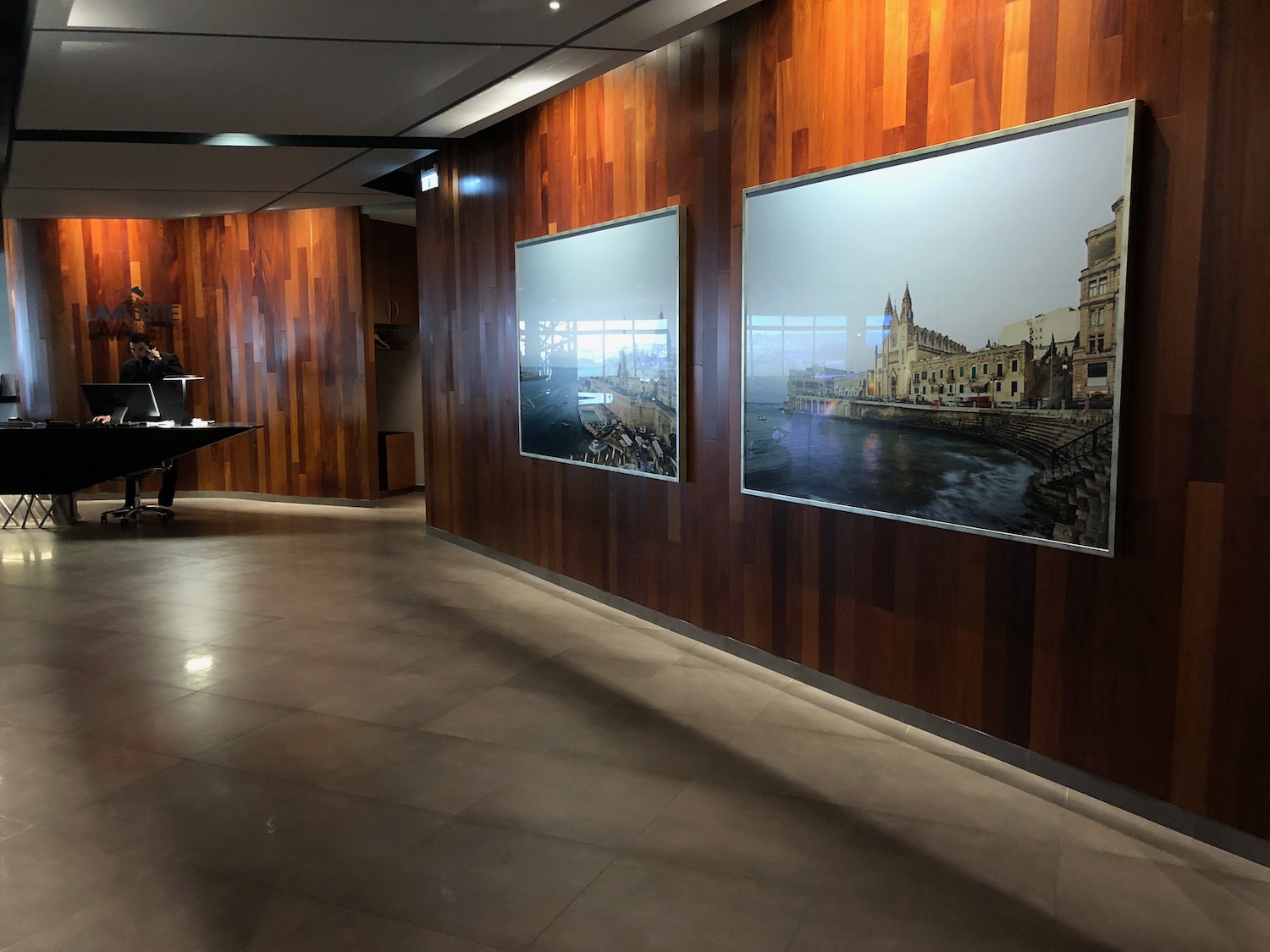 a man standing in front of a wall with pictures on it