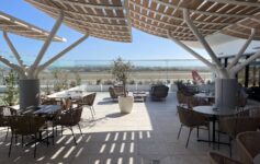 a patio with tables and chairs