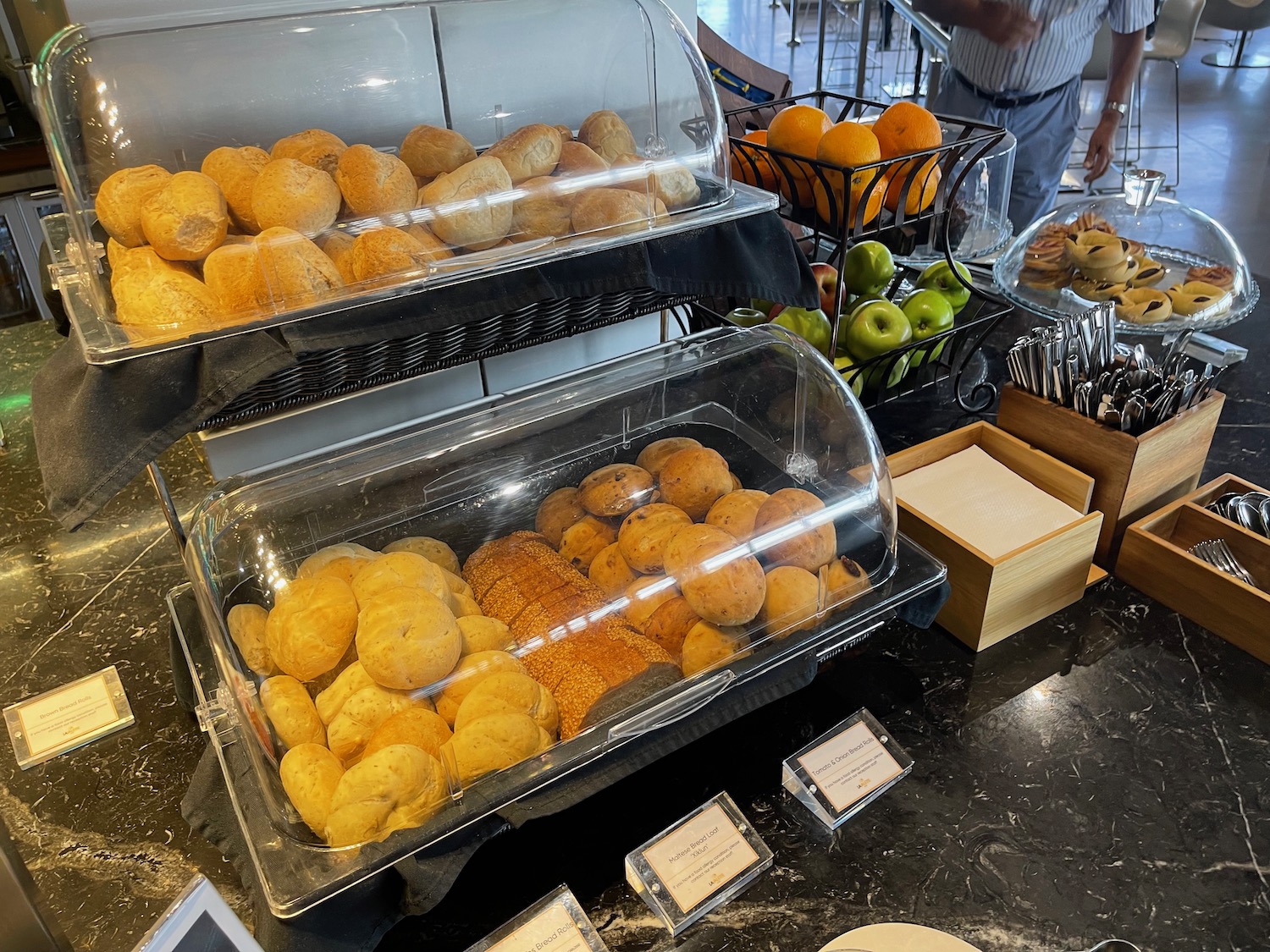 a display of bread rolls and oranges