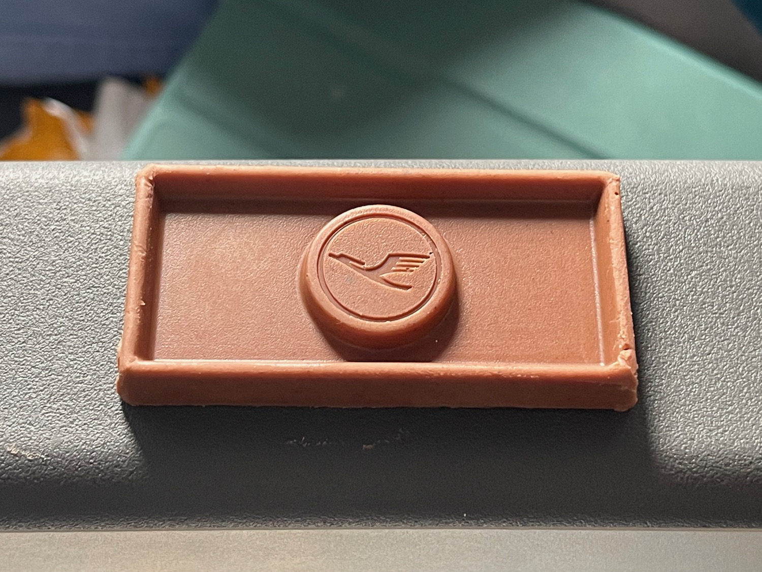 a brown rectangular object with a logo on it