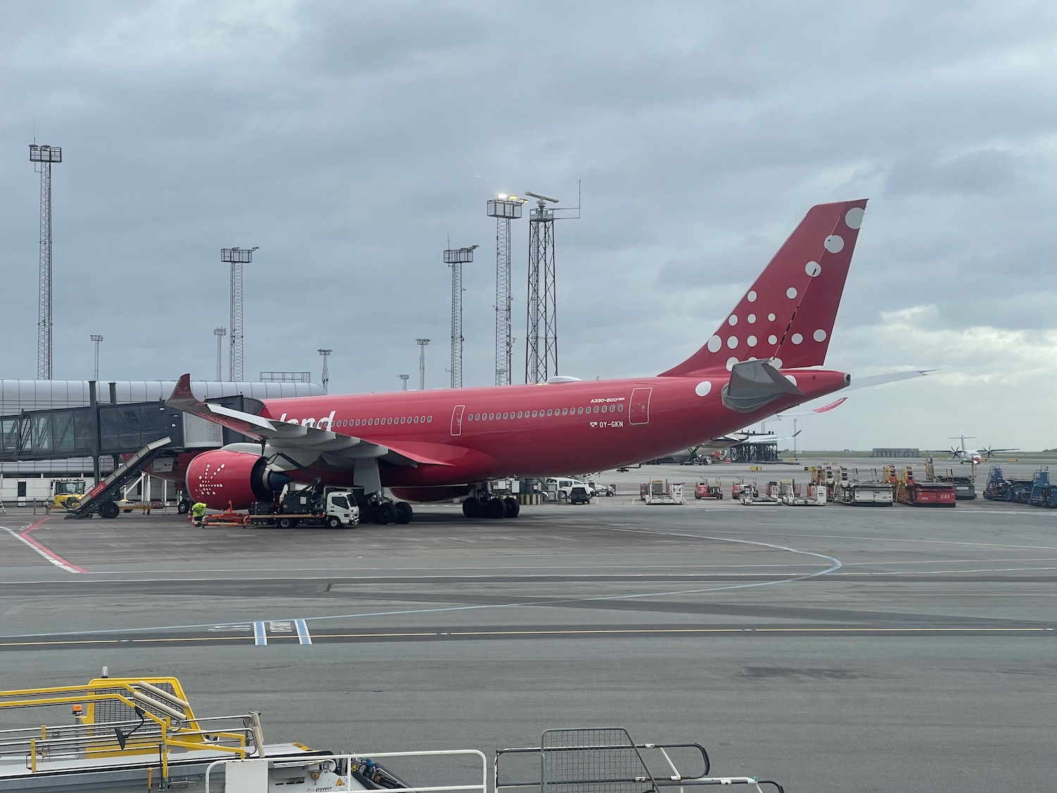 a red airplane on a runway