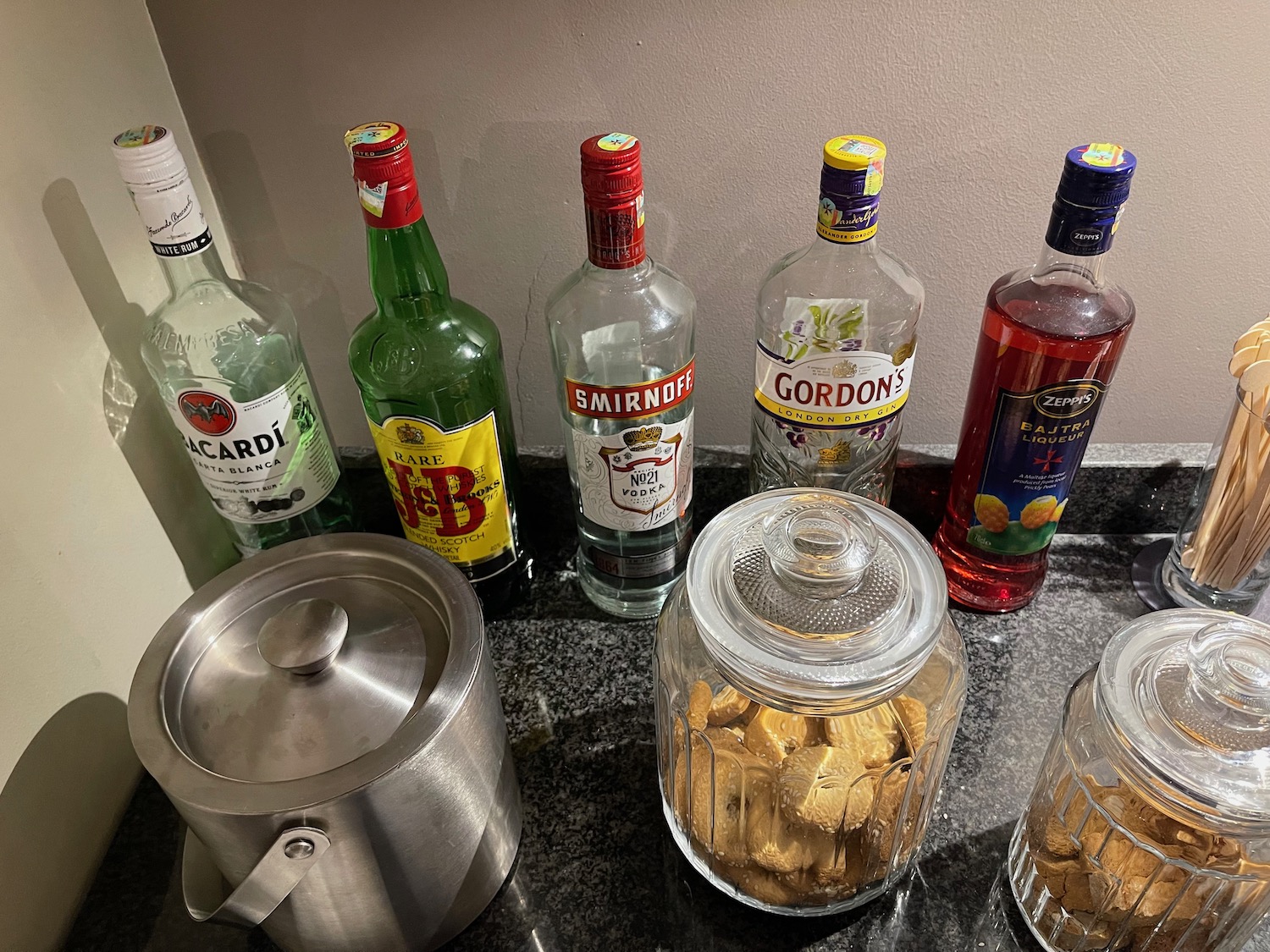 a group of bottles of liquor and a pot of food