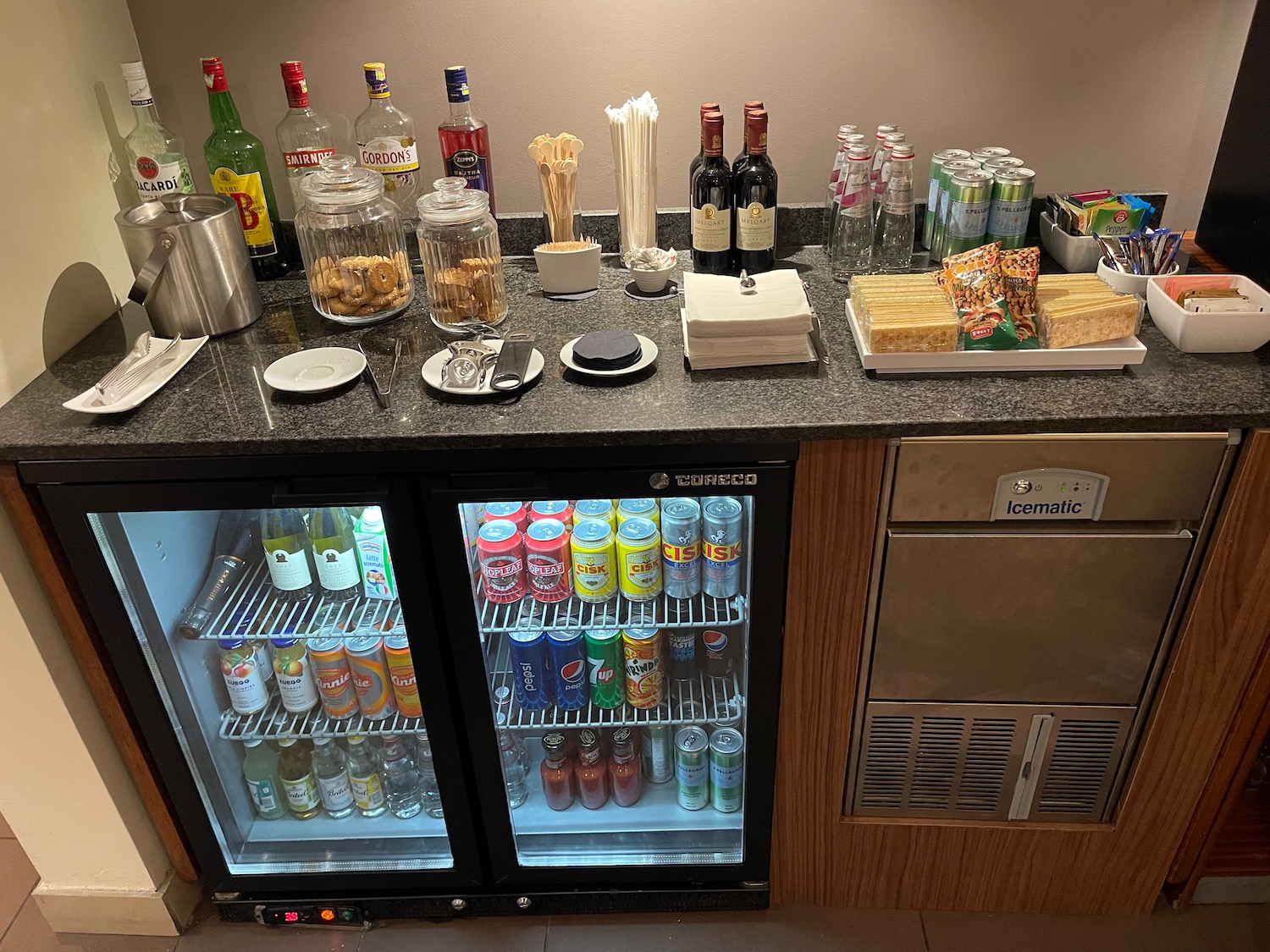 a bar with drinks and snacks