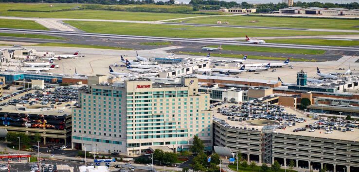 an aerial view of a airport with many airplanes and parking lots