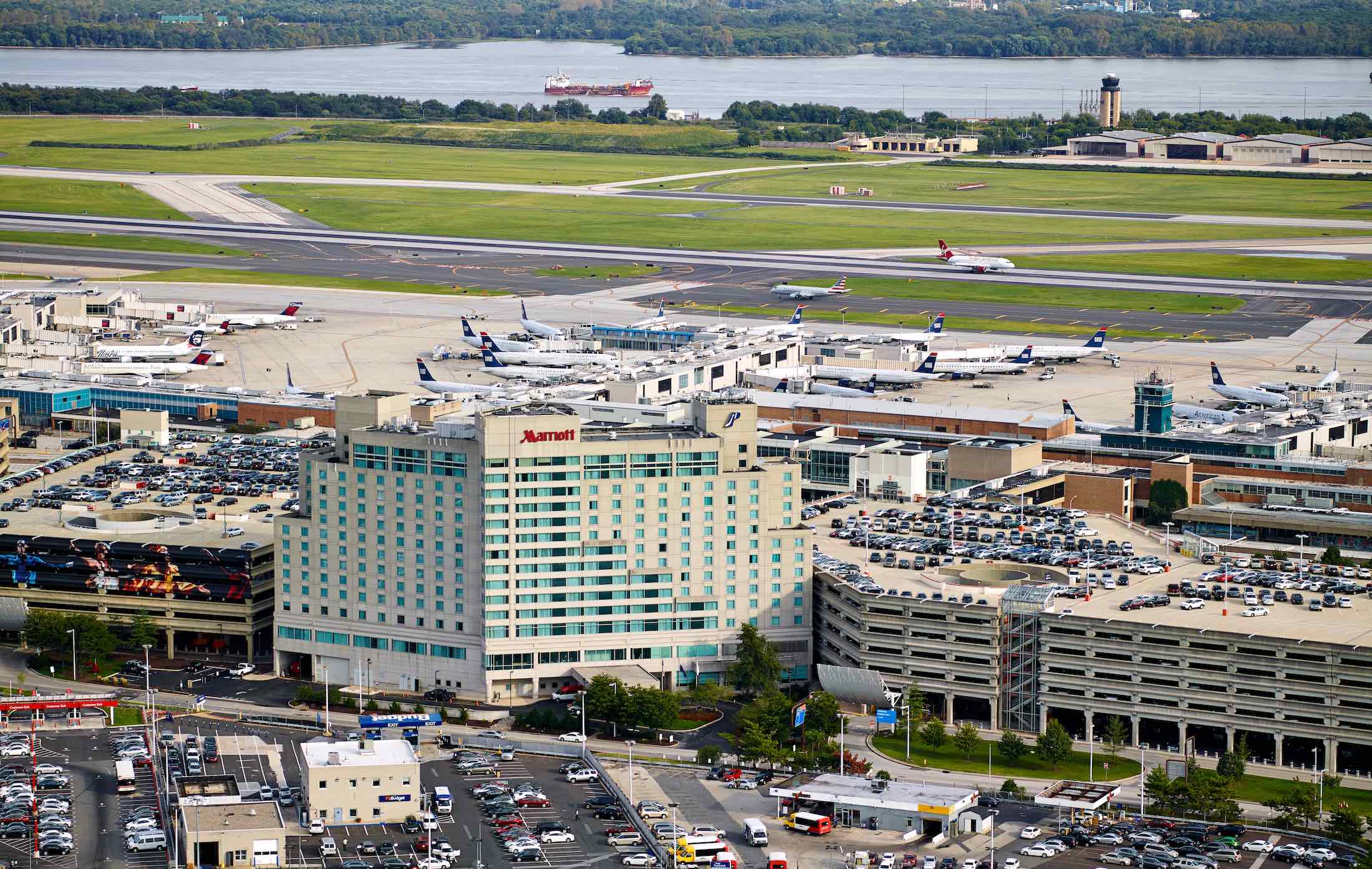 an aerial view of a airport with many airplanes and parking lots