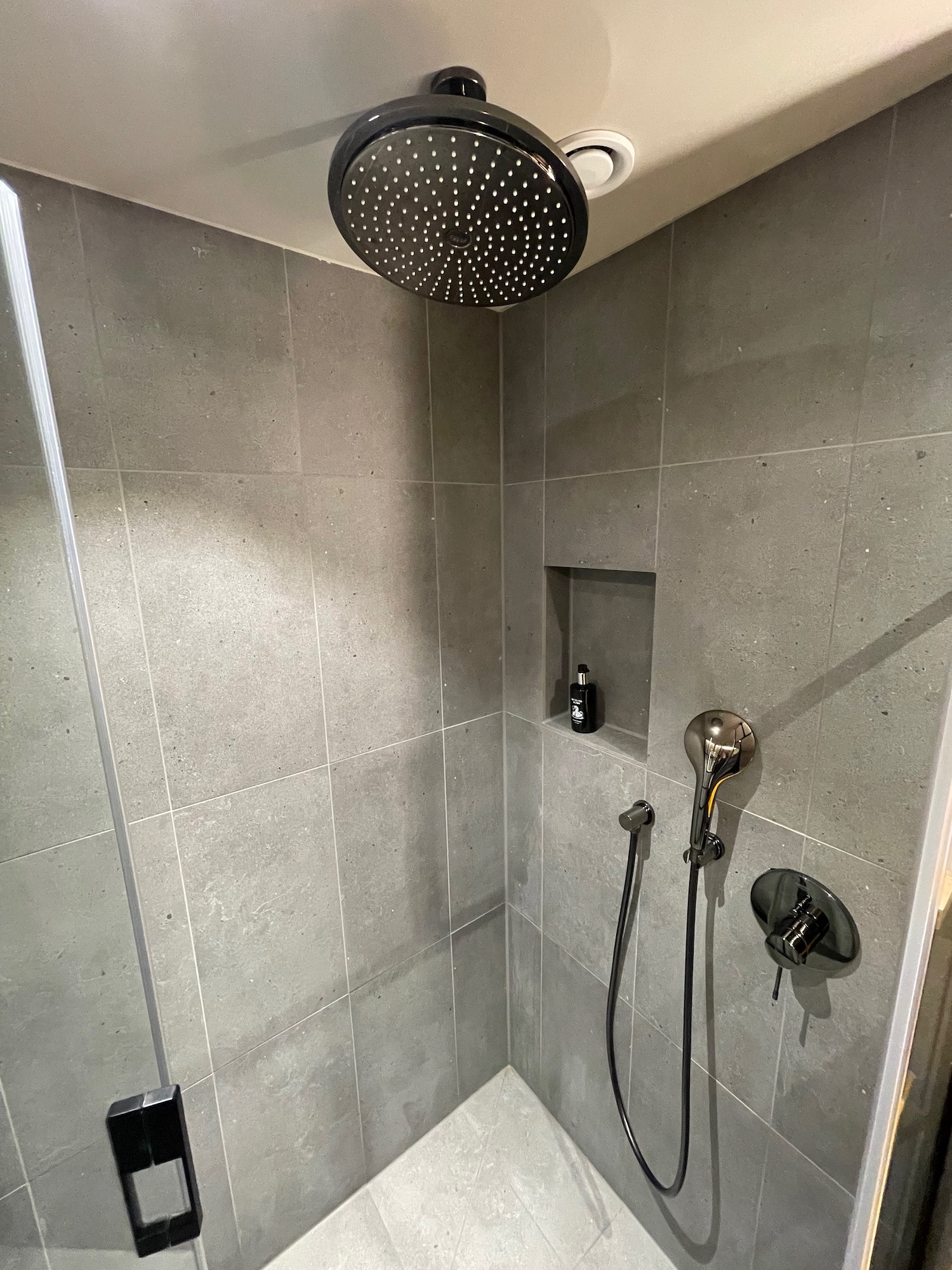 a shower with a shower head and a shower head