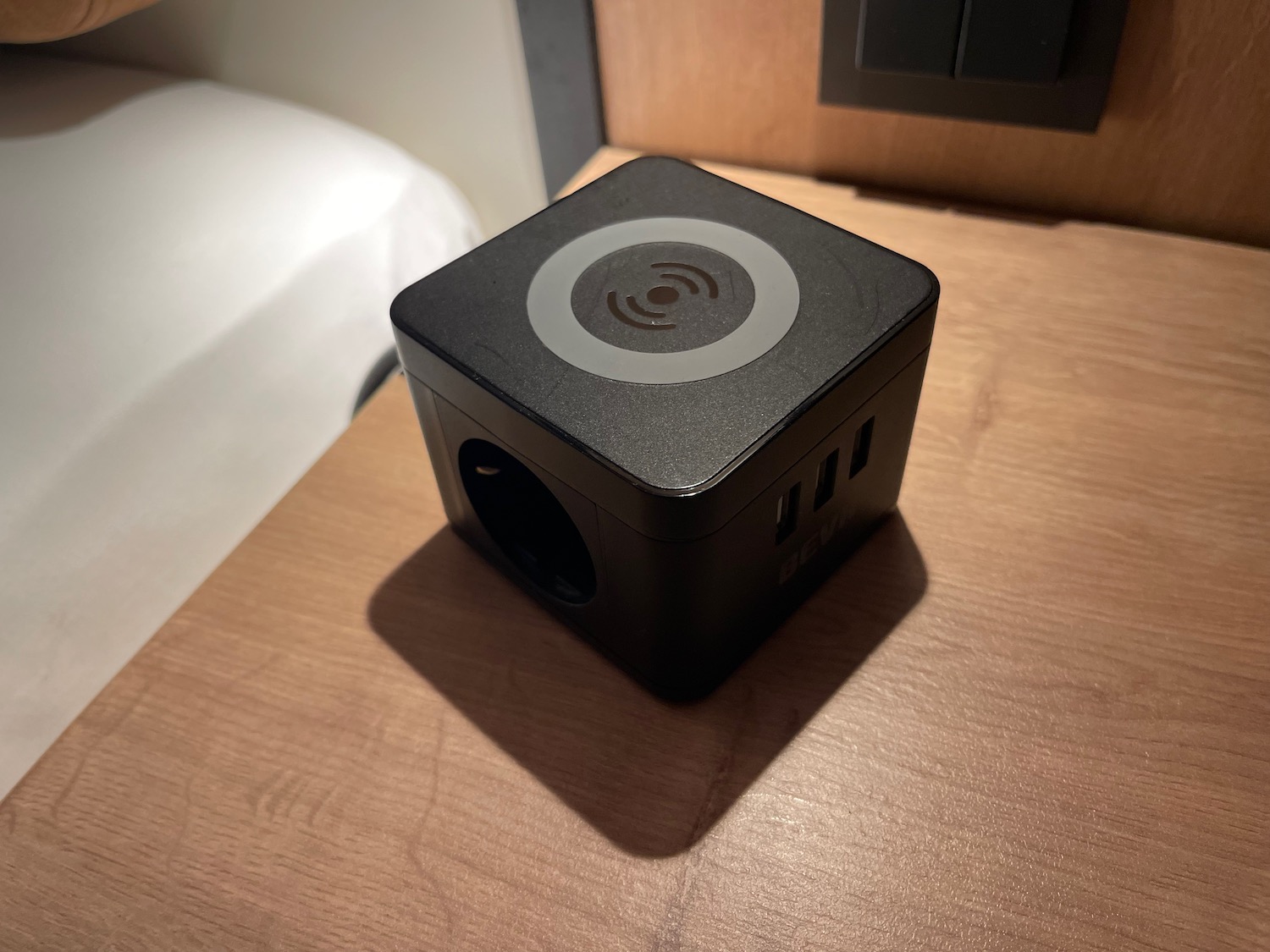 a black square device on a wood surface