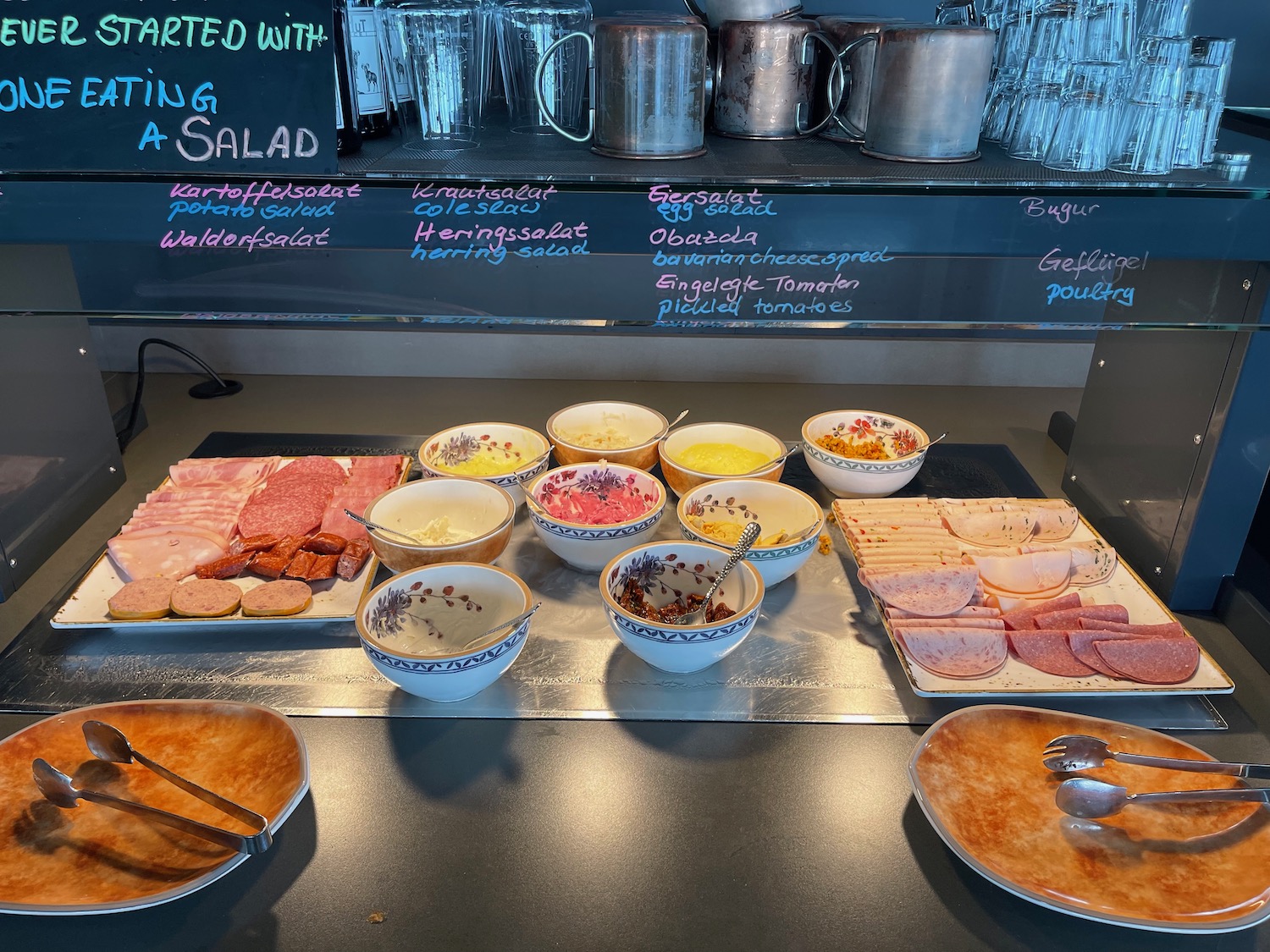 a table with bowls of food and utensils